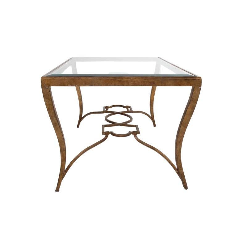 A Bernhardt antiqued gilt metal and glass top cocktail table.  The epitome of glamour and sophistication, the modern Hollywood Regency style coffee table combines timeless elegance with contemporary design to create a stunning focal point for your