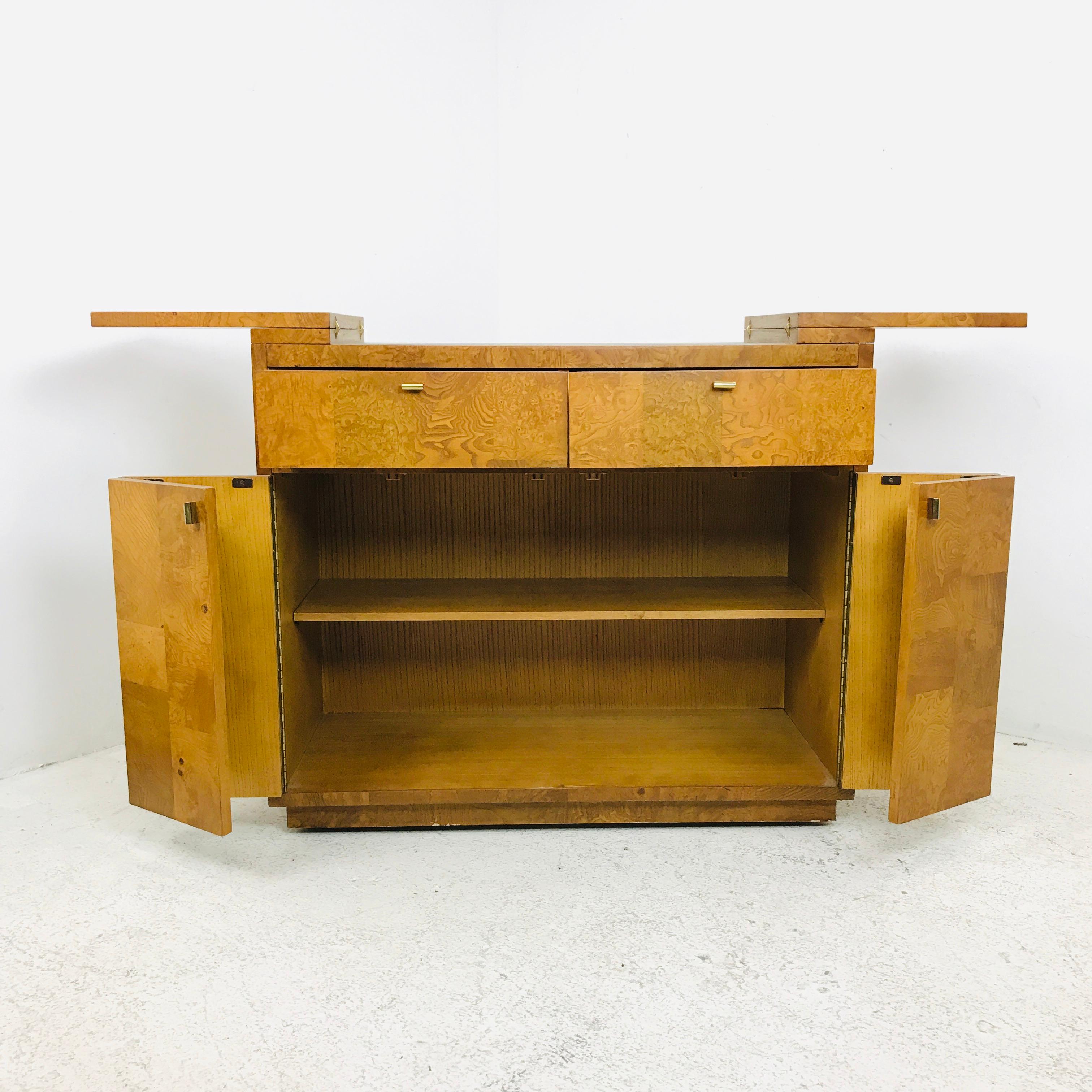 Beautiful burl wood bar cabinet by Bernhardt. Finished on all four sides. The flip open top has a black laminate serving area.