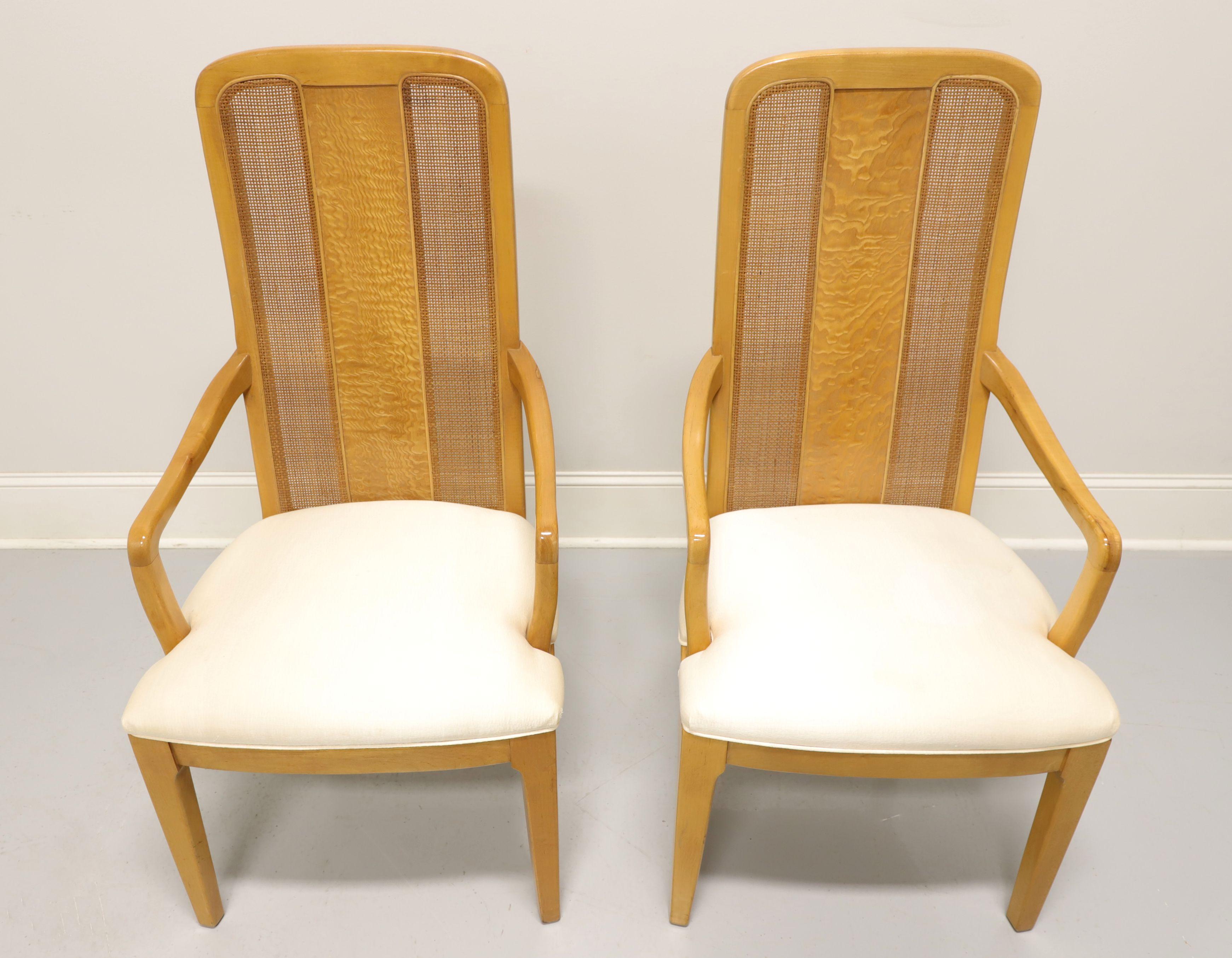 A pair of Contemporary style dining armchairs by Bernhardt Furniture. Maple with burl & cane back rest, rounded arms, neutral cream color fabric upholstered seat and straight front legs. Made in North Carolina, USA, in the late 20th