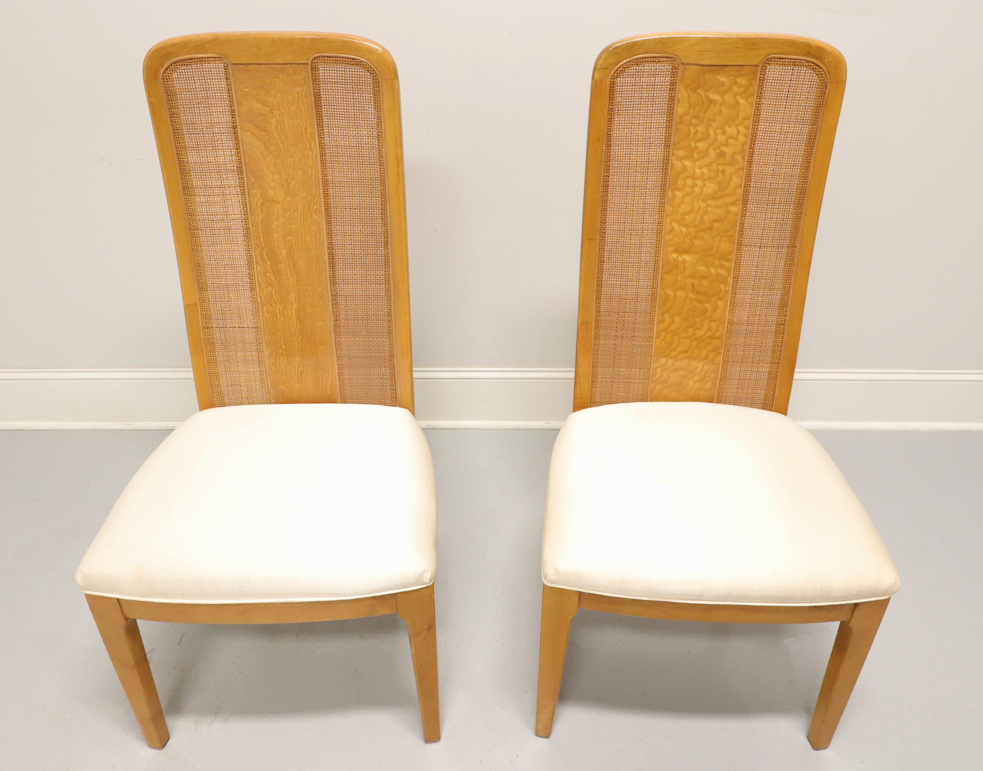 A pair of Contemporary style dining side chairs by Bernhardt Furniture. Maple with burl & cane back rest, neutral cream color fabric upholstered seat and straight front legs. Made in North Carolina, USA, in the late 20th Century.

Measures: overall: