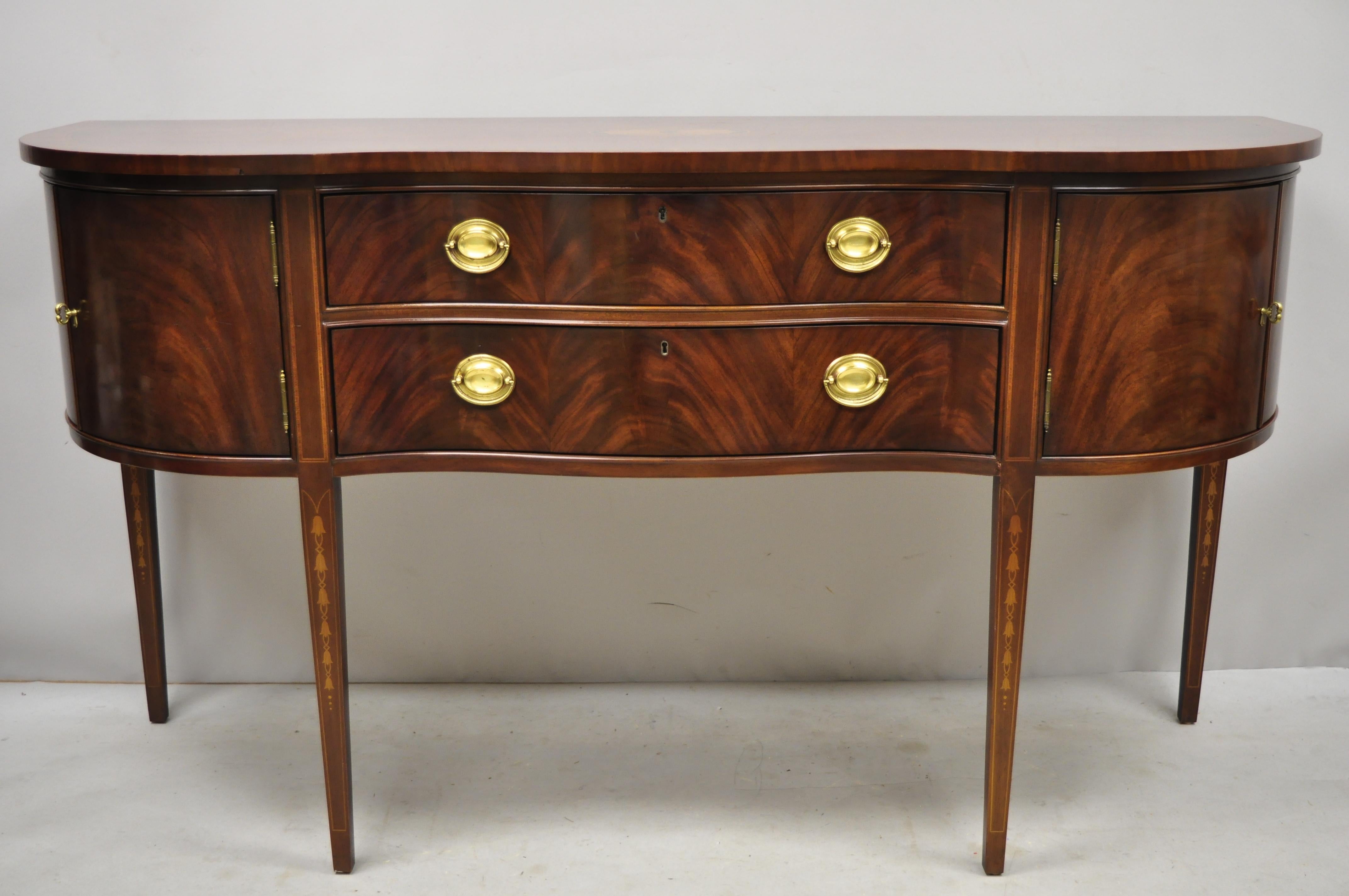 Bernhardt Centennial Collection mahogany serpentine front Hepplewhite sideboard. Item features serpentine front, bellflower inlay, banded and inlaid top, beautiful wood grain, 4 swing doors, working lock and key (key bent, but works), 2 dovetailed