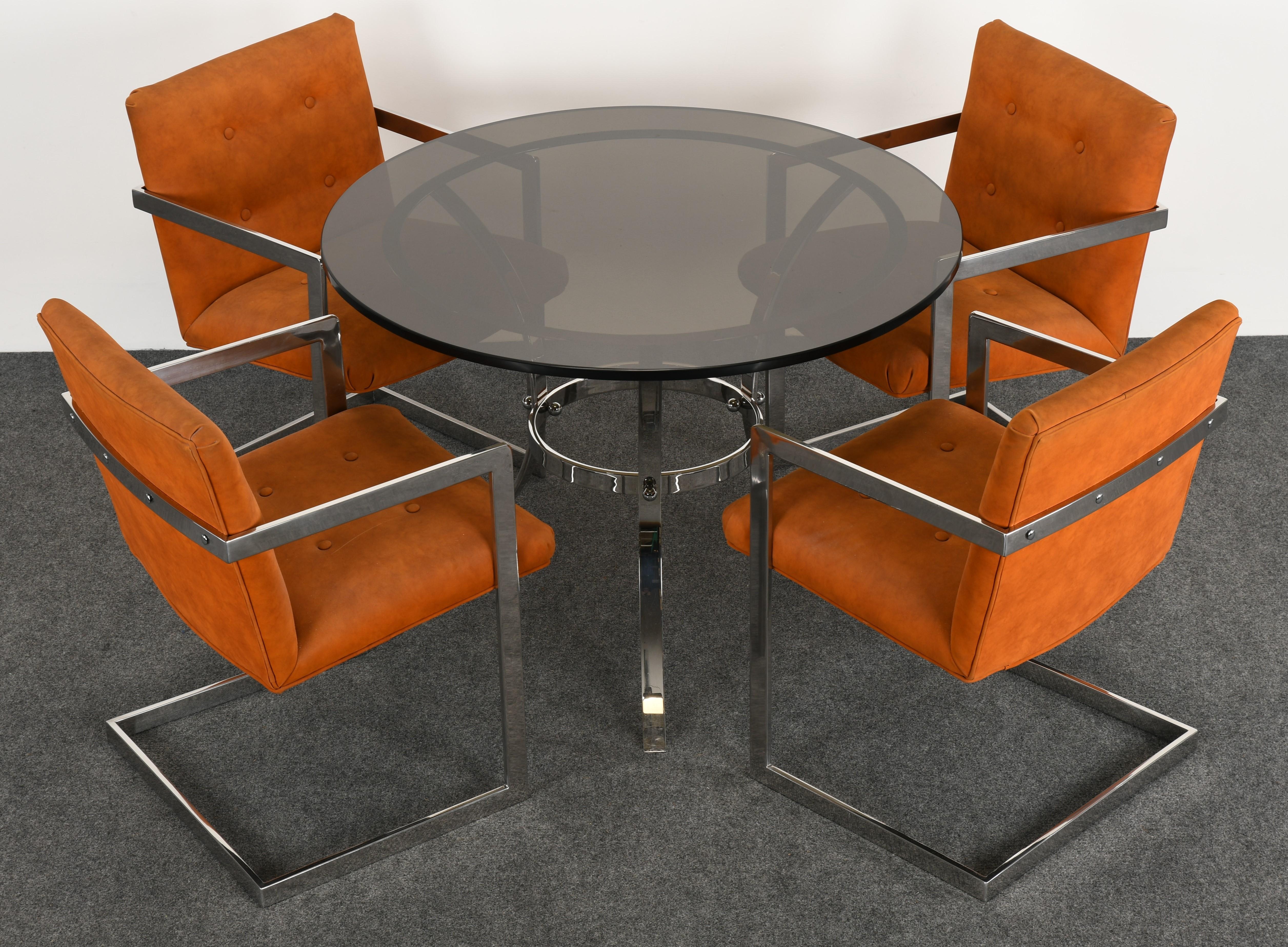 A modern chrome dining set by Bernhardt Furniture Company. This Milo Baughman style dinette set includes a chrome dining table with smokey glass and a set of four orange faux suede armchairs. This set in very good condition with age-appropriate
