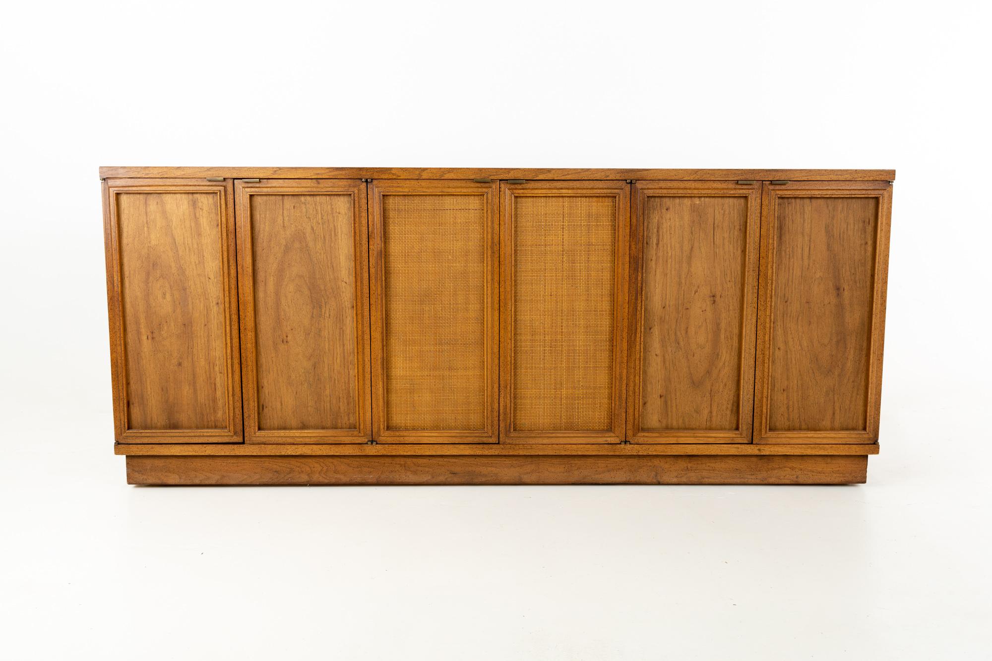 Bernhardt furniture Mid Century cane front credenza buffet
This piece is 70 wide x 17.75 deep x 29.5 inches high

This price includes getting this piece in what we call restored vintage condition. That means the piece is permanently fixed upon