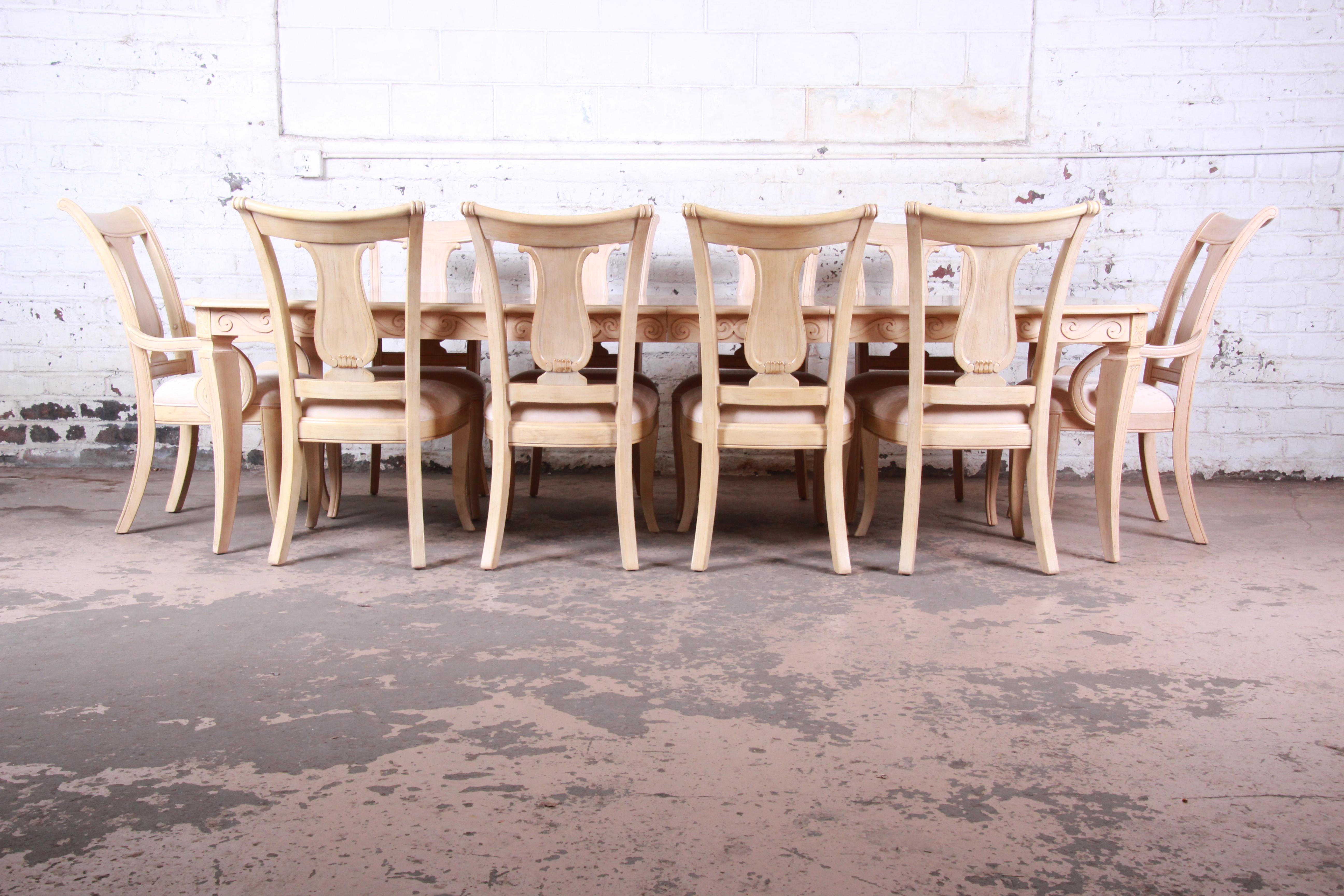 A gorgeous Mediterranean style carved maple dining table with ten harp back chairs

Made by Bernhardt Furniture

USA, 1990s

Maple and upholstery

Measures:
Table - 74