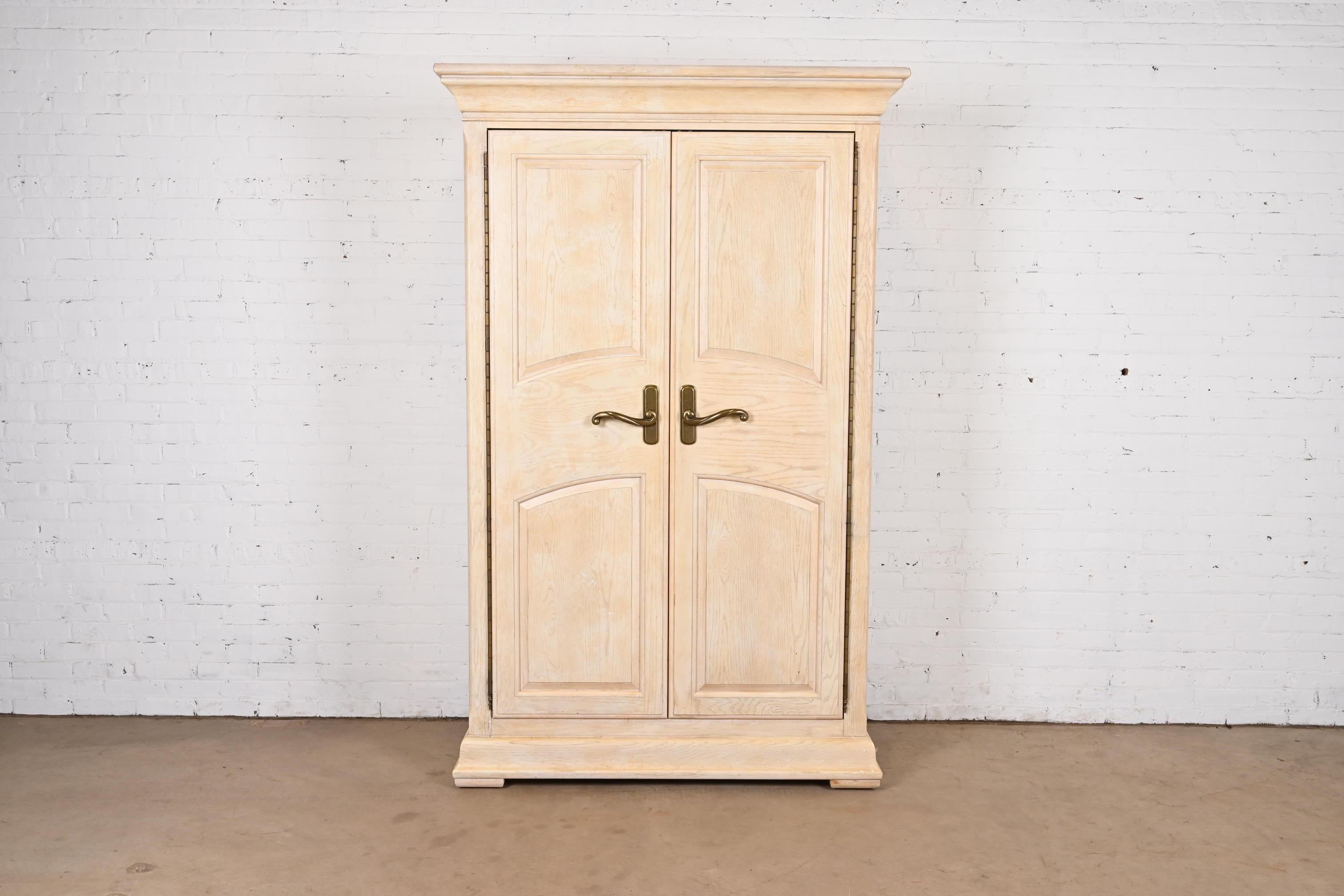 A gorgeous Mediterranean or Coastal style whitewashed oak armoire dresser or wardrobe

By Bernhardt Furniture

USA, Circa 1990s

Measures: 52.75