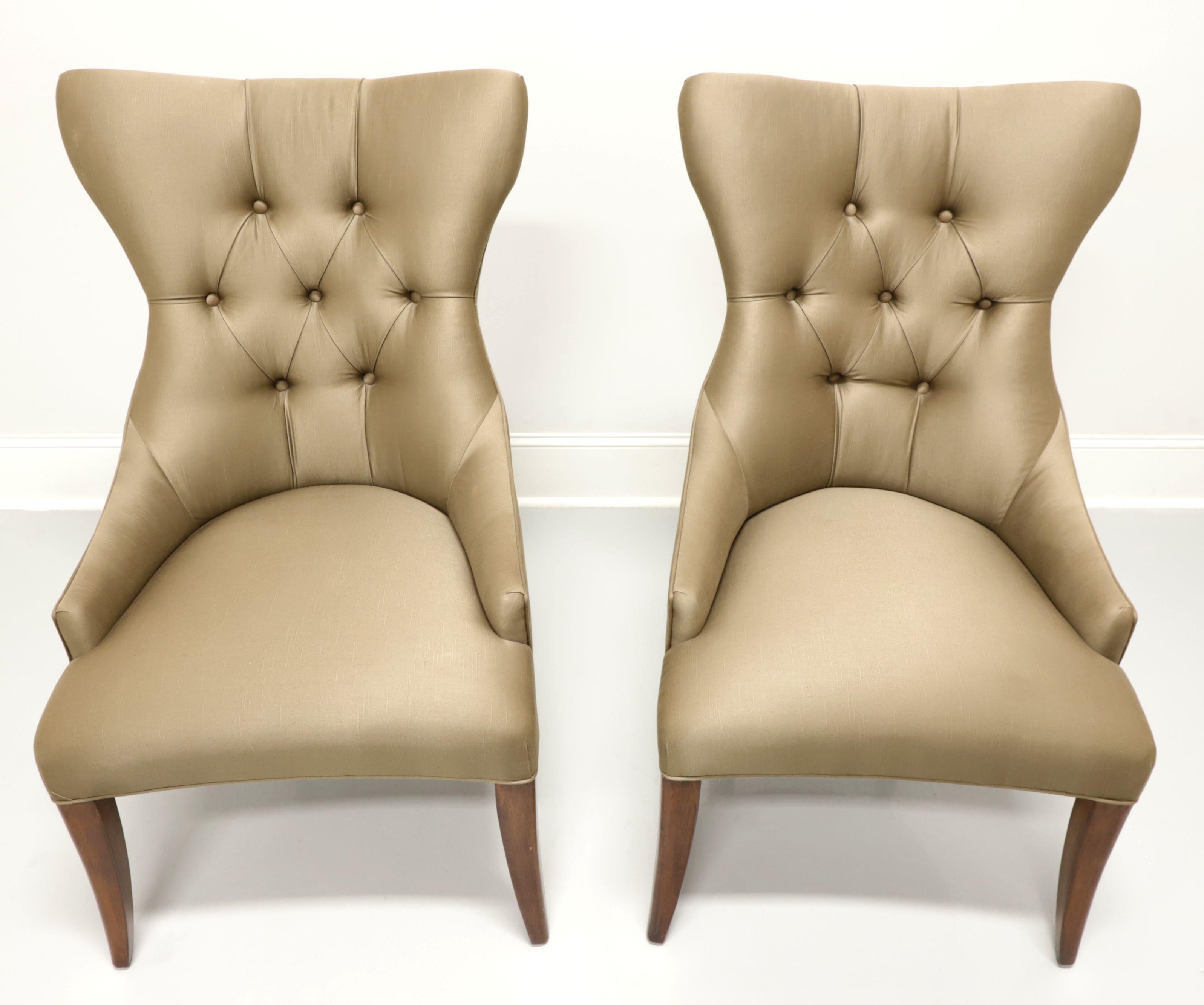 A pair of Contemporary style dining side chairs by Bernhardt Furniture, from their Opus XIX Collection. Solid wood frame with a walnut finish and fabric upholstered. Features a high back with slight wings, button tufted, low arms, high sheen satin