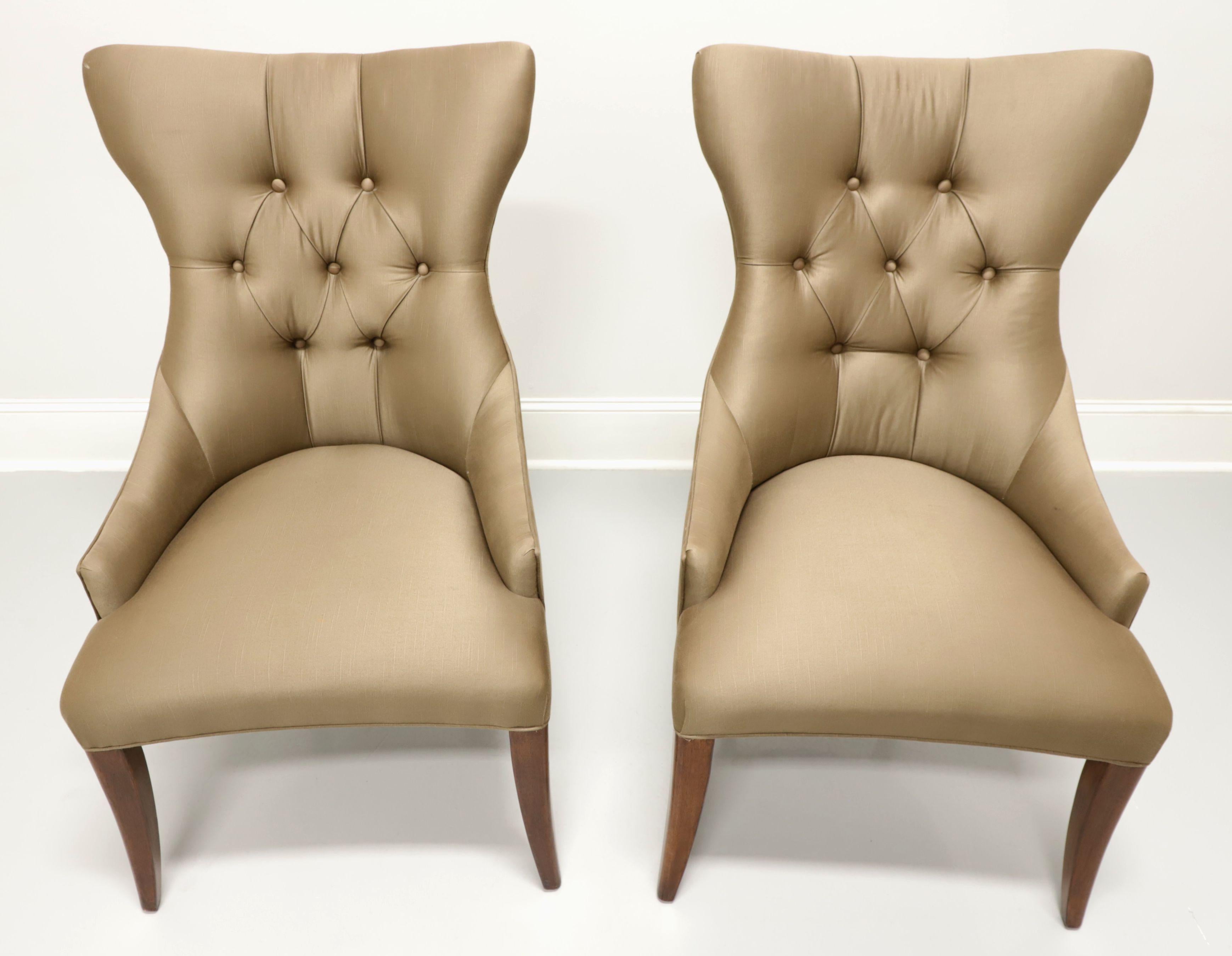 A pair of Contemporary style dining side chairs by Bernhardt Furniture, from their Opus XIX Collection. Solid wood frame with a walnut finish and fabric upholstered. Features a high back with slight wings, button tufted, low arms, high sheen satin