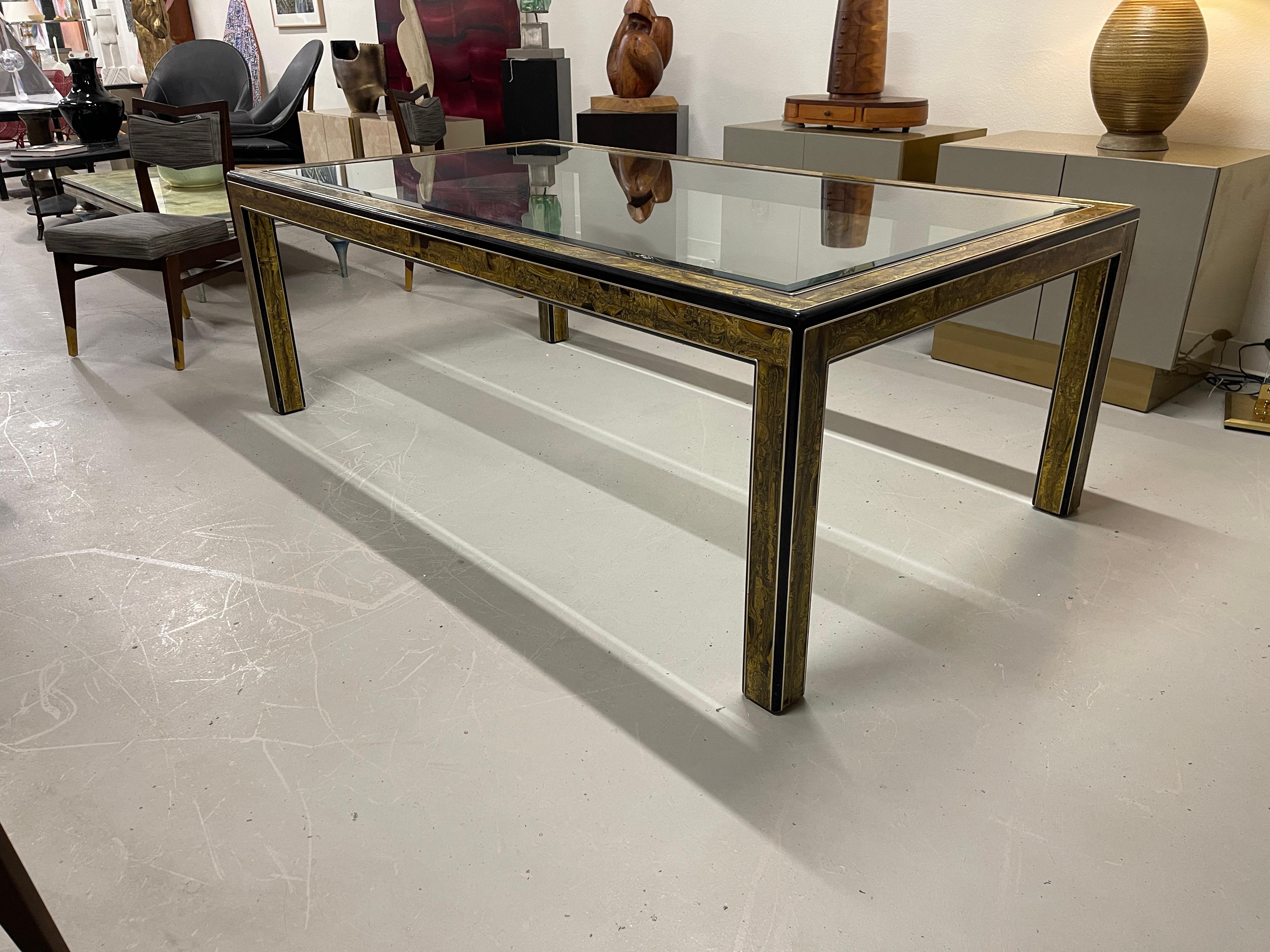 Beautiful Bernhard Rohne dining table for Mastercraft. Out of a elegant Palm Springs estate. The table is in good vintage condition with some wear to the black paint and some missing spots. Brass inlay is in good condition.