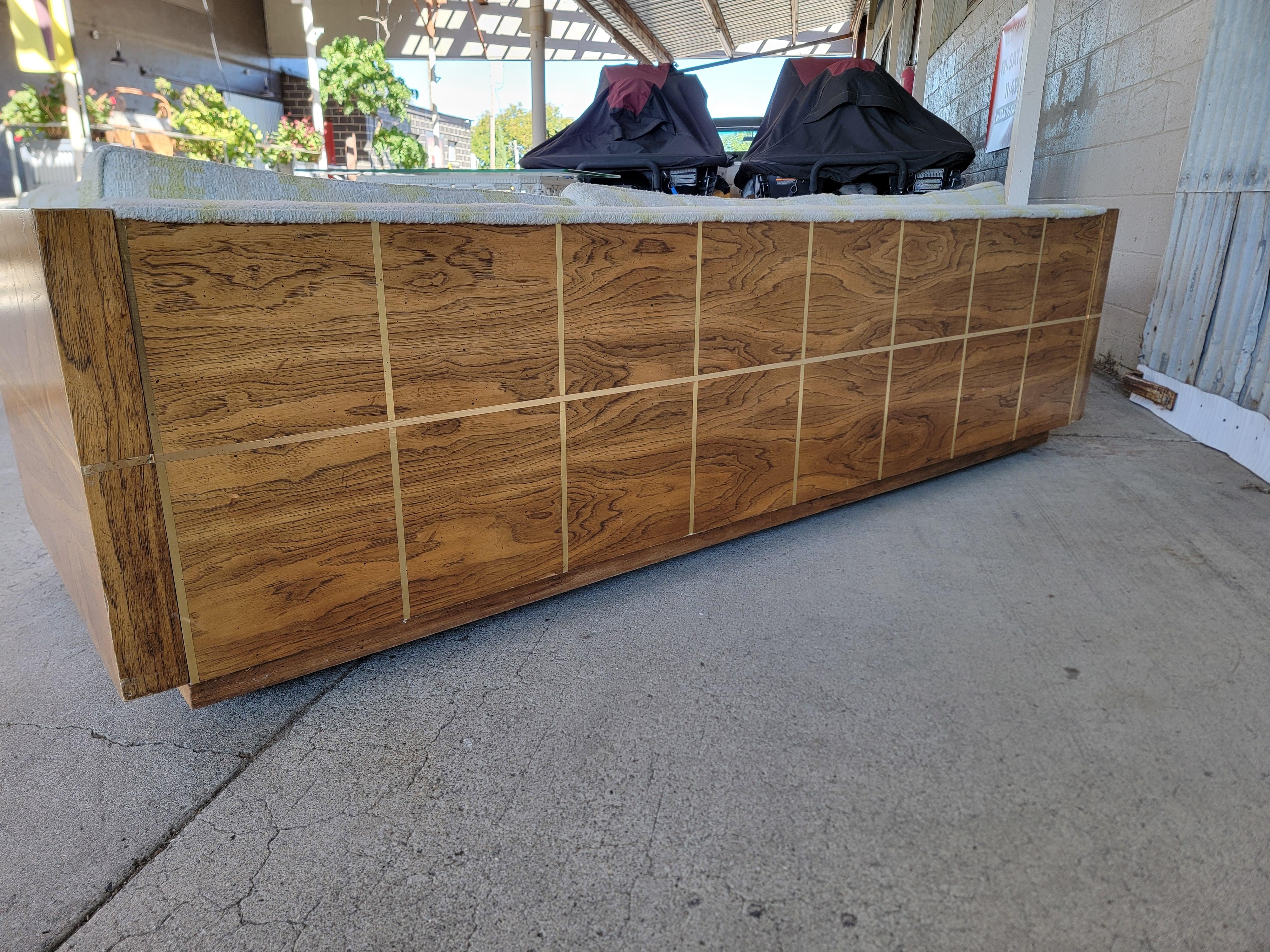 Bernhardt Furniture Company. Circa. 1970's. Designed in the manner of Milo Baughman. Wood sides and back. Nice addition to a Hollywood Regency or Mid-Century Modern interior. Very good original condition with original upholstery. Original castors