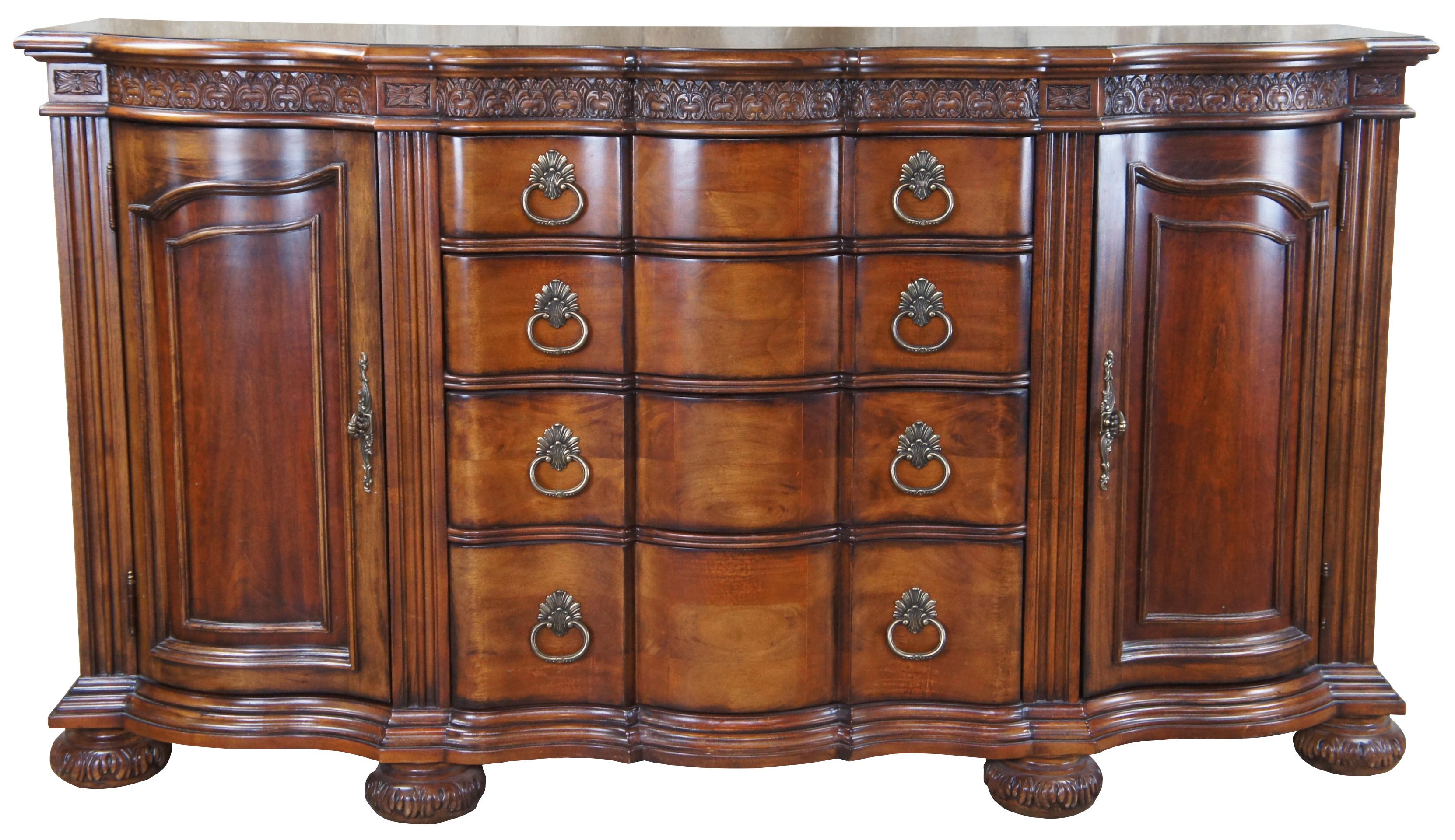 A large late 20th century sideboard by Bernhardt Furniture. Made from mahogany with a rectangular form featuring a serpentine breakfront, French Louis XV style carvings and bun feet. Includes 4 drawers flanked by outer cabinets.

 Bernhardt