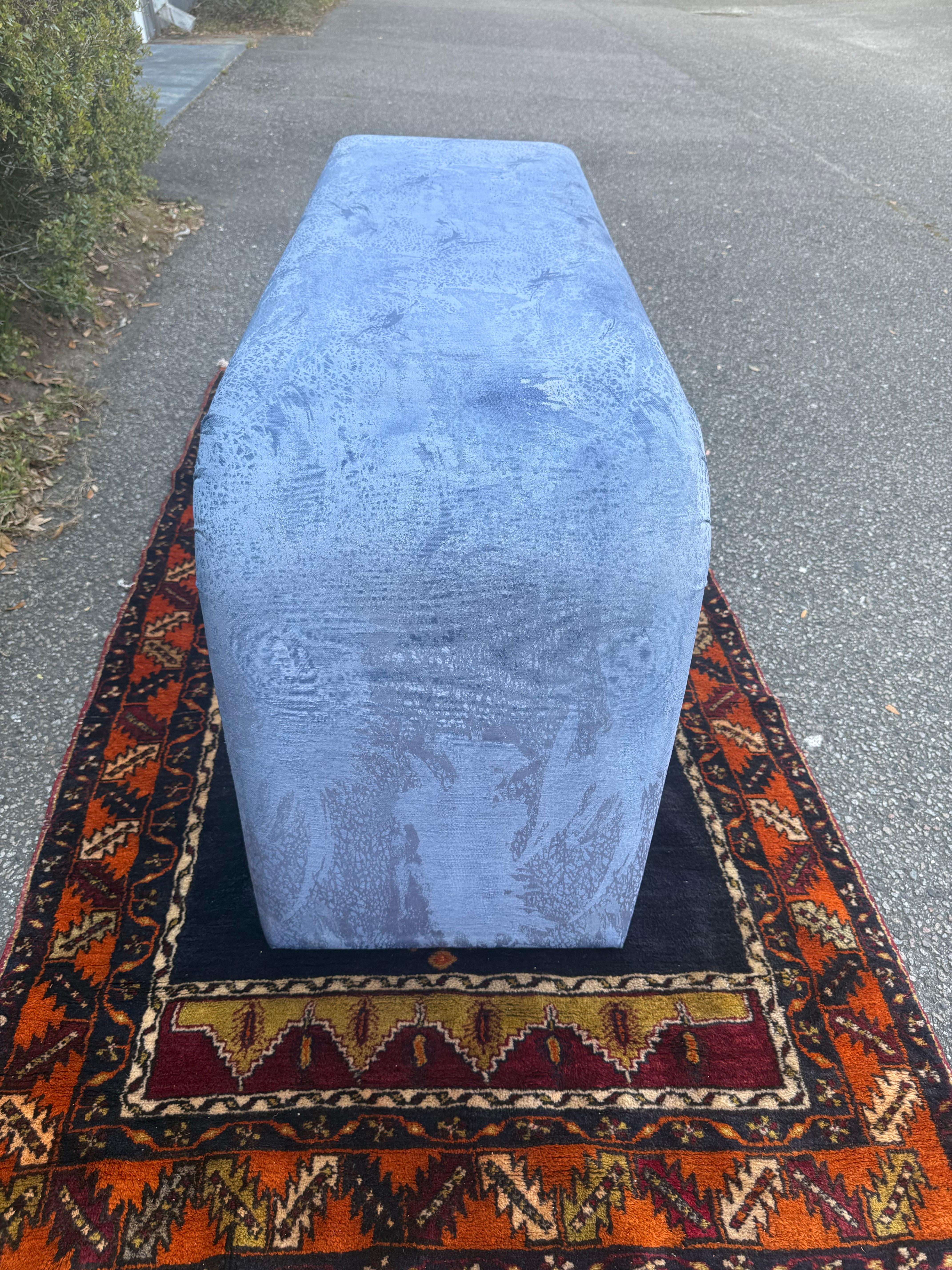 A fantastic fully upholstered waterfall console table that has the original fabric and has been hand cleaned and hand dyed to a really pretty blue… so it still maintains the original Bernhardt Flair pattern.