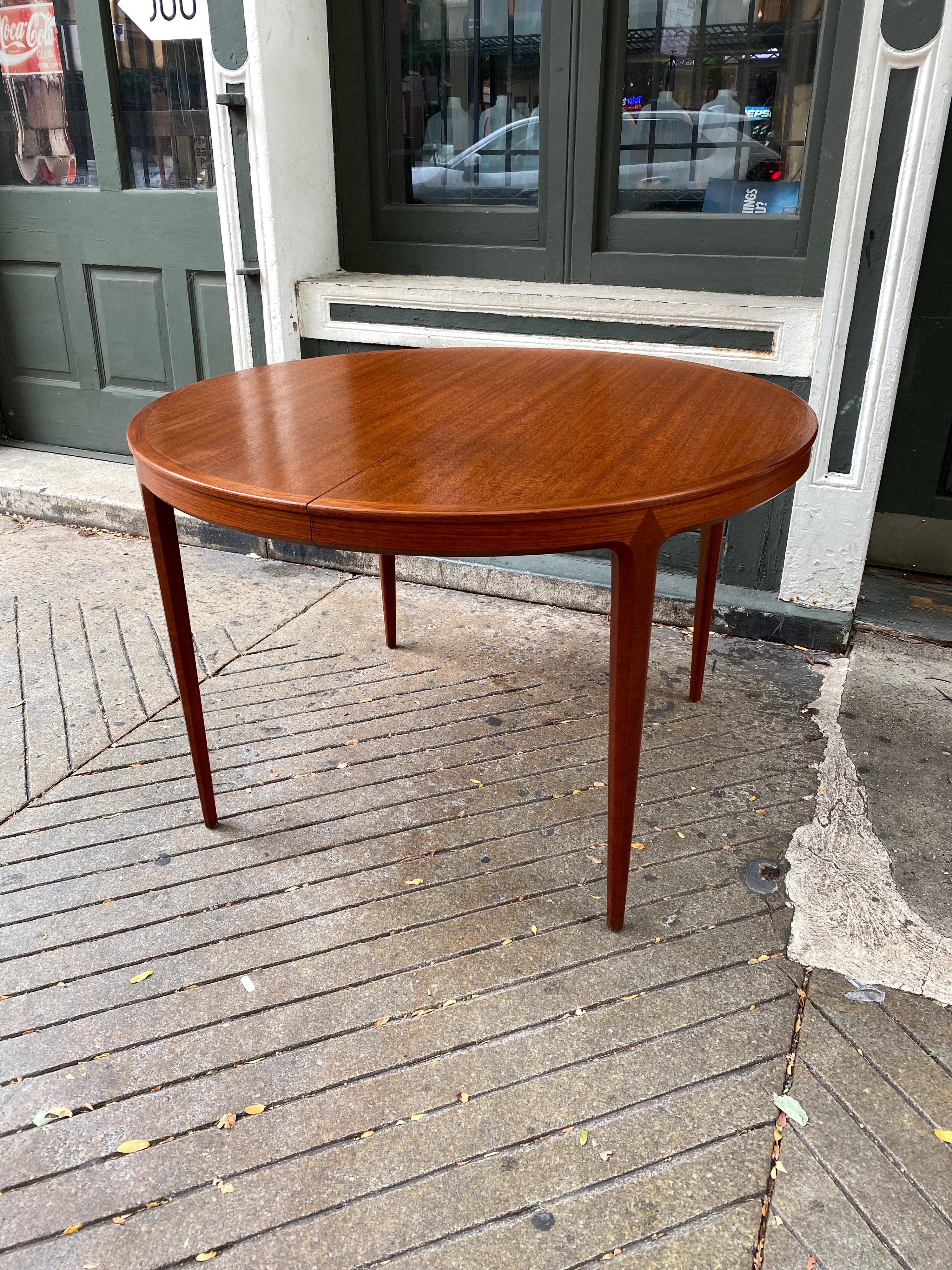 B. Fridhagen for Bodafors round teak dining table. One of the most beautifully made tables I have ever seen! The attention to detail is outstanding! Amazing beveled and angled legs tie in effortlessly to the skirt of the table. Two 21.5