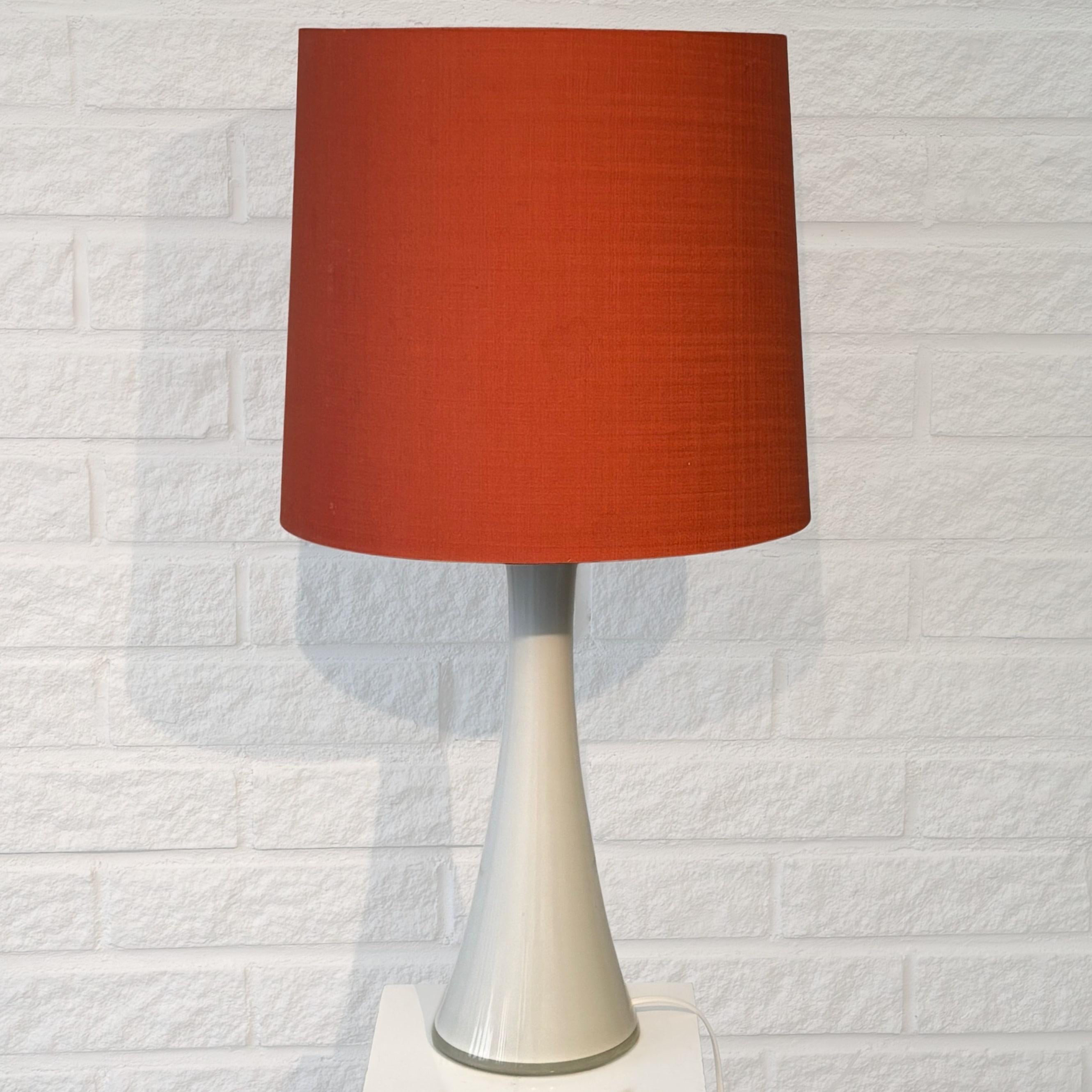 A sleek Scandinavian table lamp, model B-015, designed by Bernt Nordstedt and produced by the Swedish manufacturer Bergbom & Co in the 1960s. Crafted from white glass with teak details and featuring a lampholder with an integrated light switch.