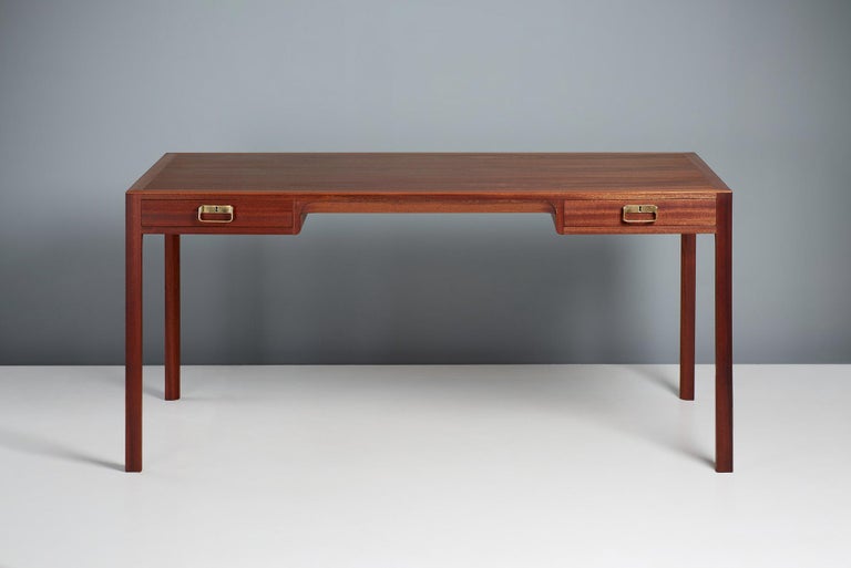Bernt Petersen Writing Desk, c1960s

Bernt Petersen designed desk, produced in Denmark by master cabinetmakers Rud. Rasmussen, Denmark in the 1960s. Solid mahogany legs and drawer fronts with veneered top. Solid oak drawer inserts with patinated