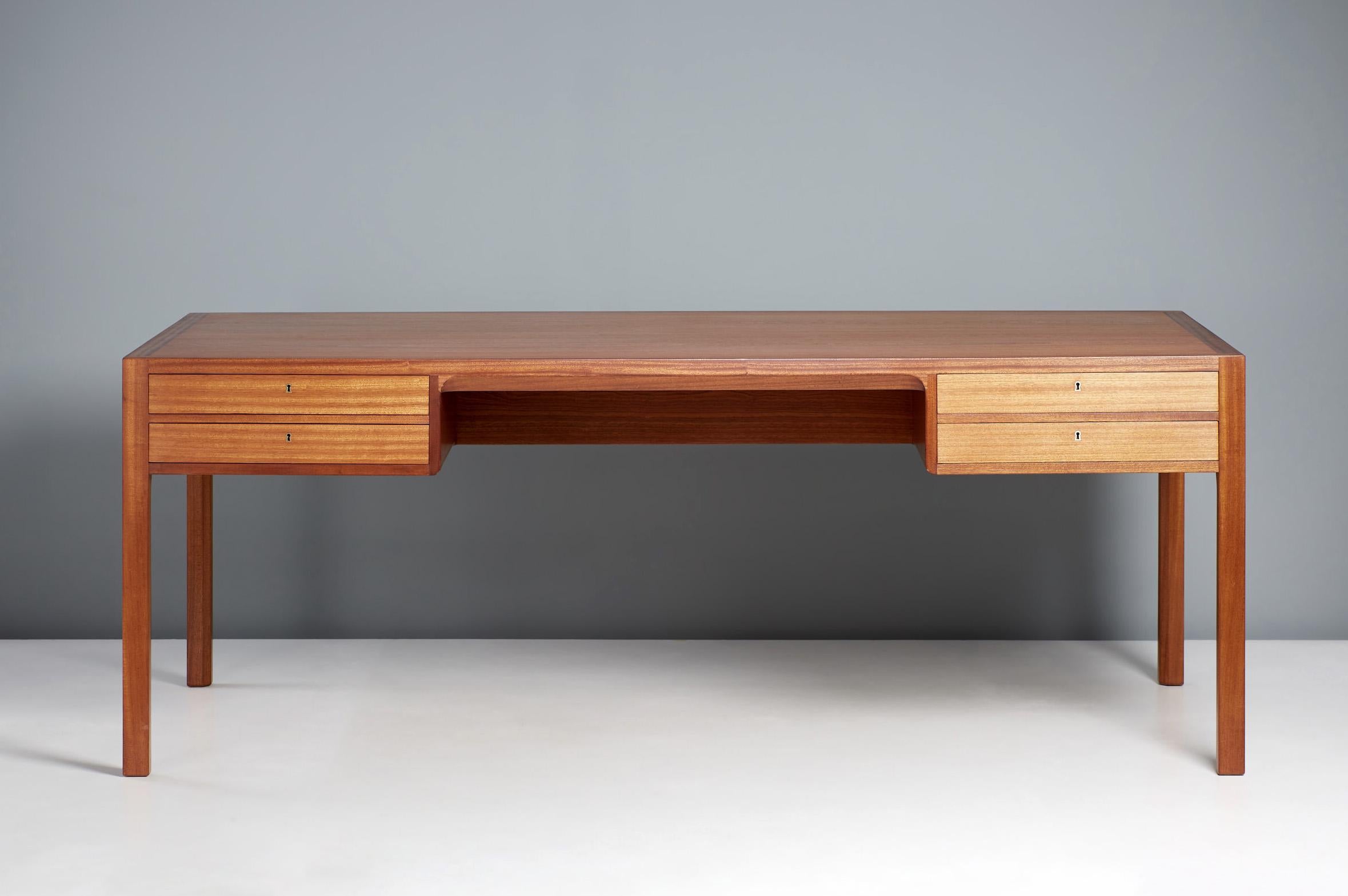 Bernt Petersen Writing Desk, circa 1960s

Produced by master cabinetmakers Rud. Rasmussen, Denmark. Solid mahogany and mahogany veneer construction with 2 drawers on either side.