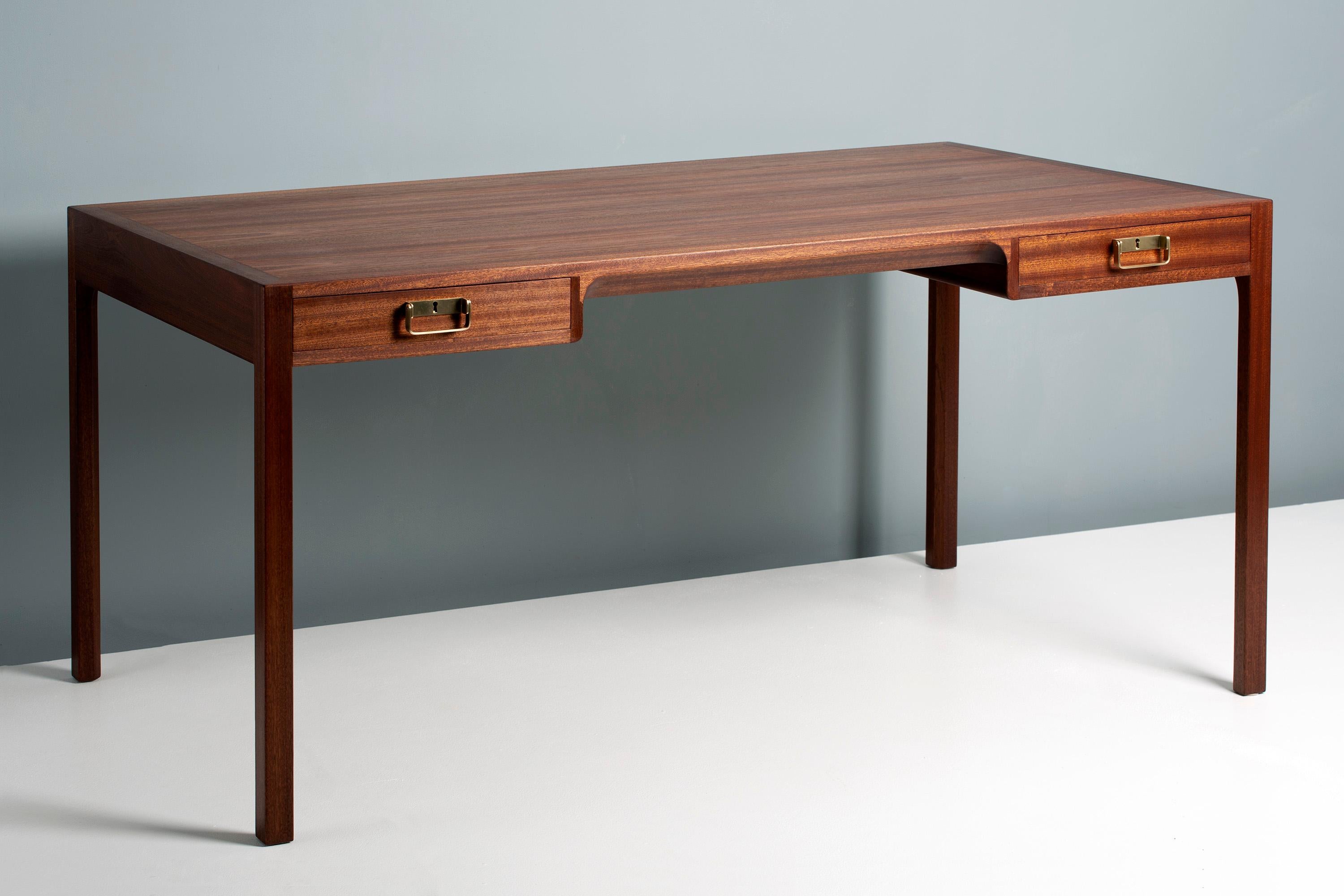 Bernt Petersen designed desk, produced in Denmark by master cabinetmakers Rud. Rasmussen, Denmark in the 1950s. Solid mahogany legs and drawer fronts, veneer top. Solid oak drawer inserts with patinated brass handles and locks.
