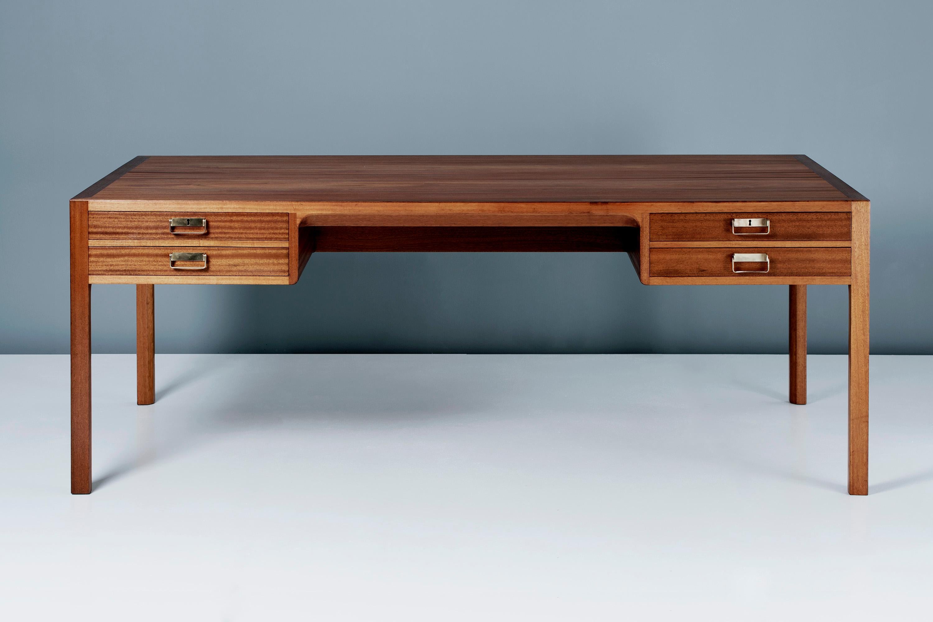Bernt Petersen

Mahogany Writing Desk, circa 1950s

Four drawer executive desk produced in Denmark by master cabinetmakers Rud. Rasmussen, Denmark. Solid mahogany legs and drawer fronts with veneered top. Solid oak drawer inserts with patinated