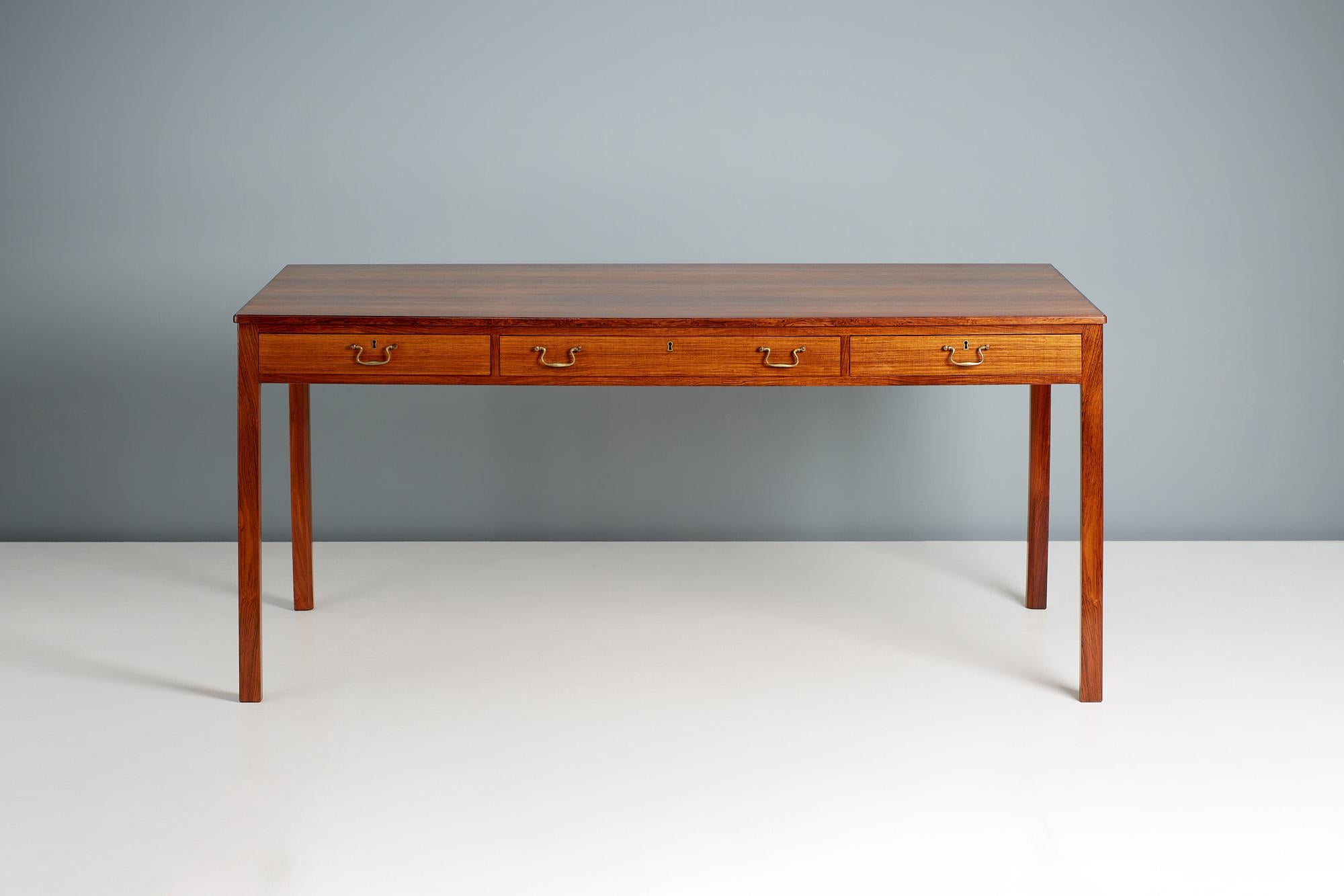 Bernt Petersen - 1950s writing desk

Stunning desk produced by master cabinetmakers Rud. Rasmussen in Denmark c1950s. The legs and drawer fronts are solid rosewood whilst the top is veneered, showcasing the exquisite grain. The desk is in