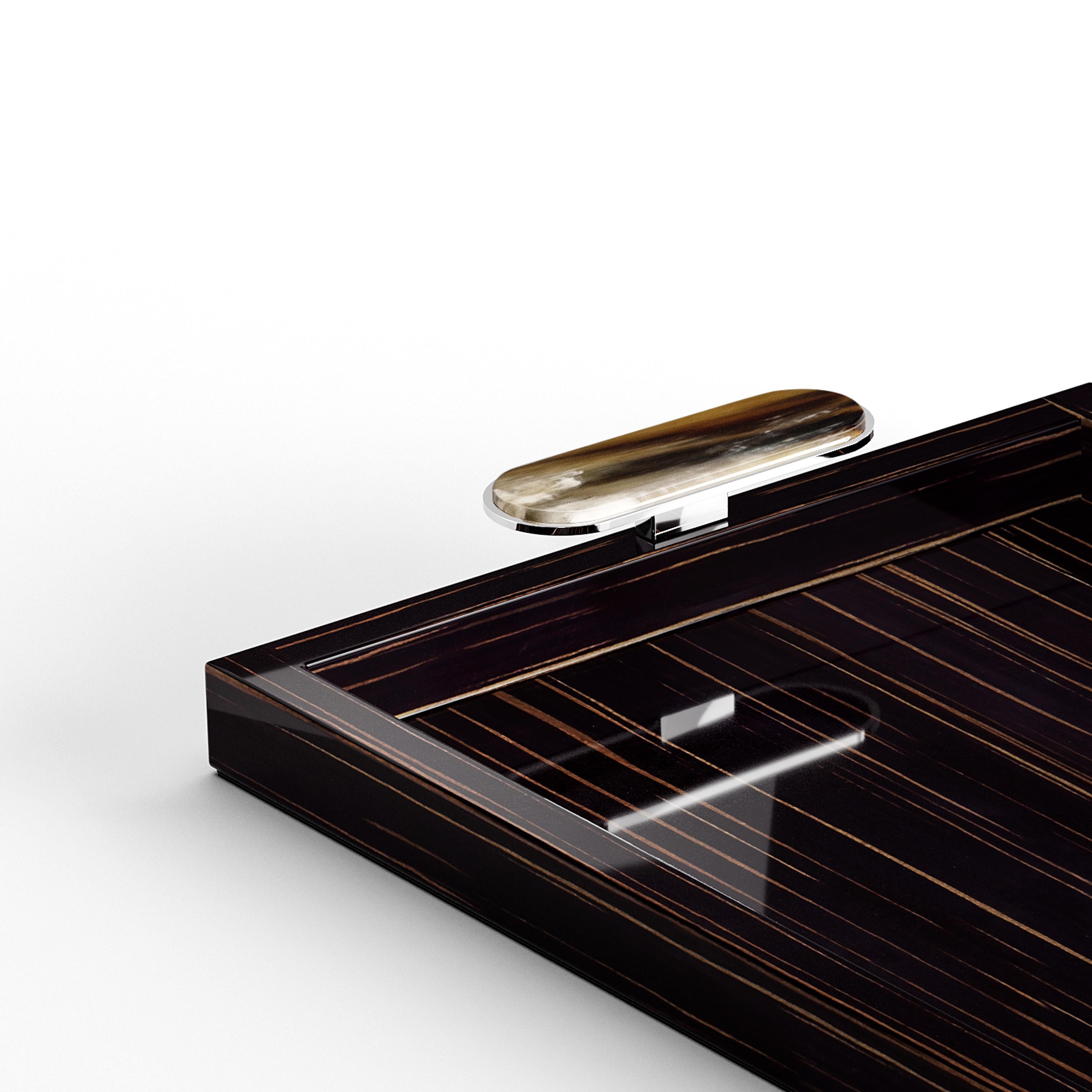 Elegant and functional, the Berro tray is ideal for serving delicacies and beverages in style. Its structure is handcrafted in glossy ebony and sports elegant handles in Corno Italiano and chromed brass. The natural tones of Corno Italiano, paired