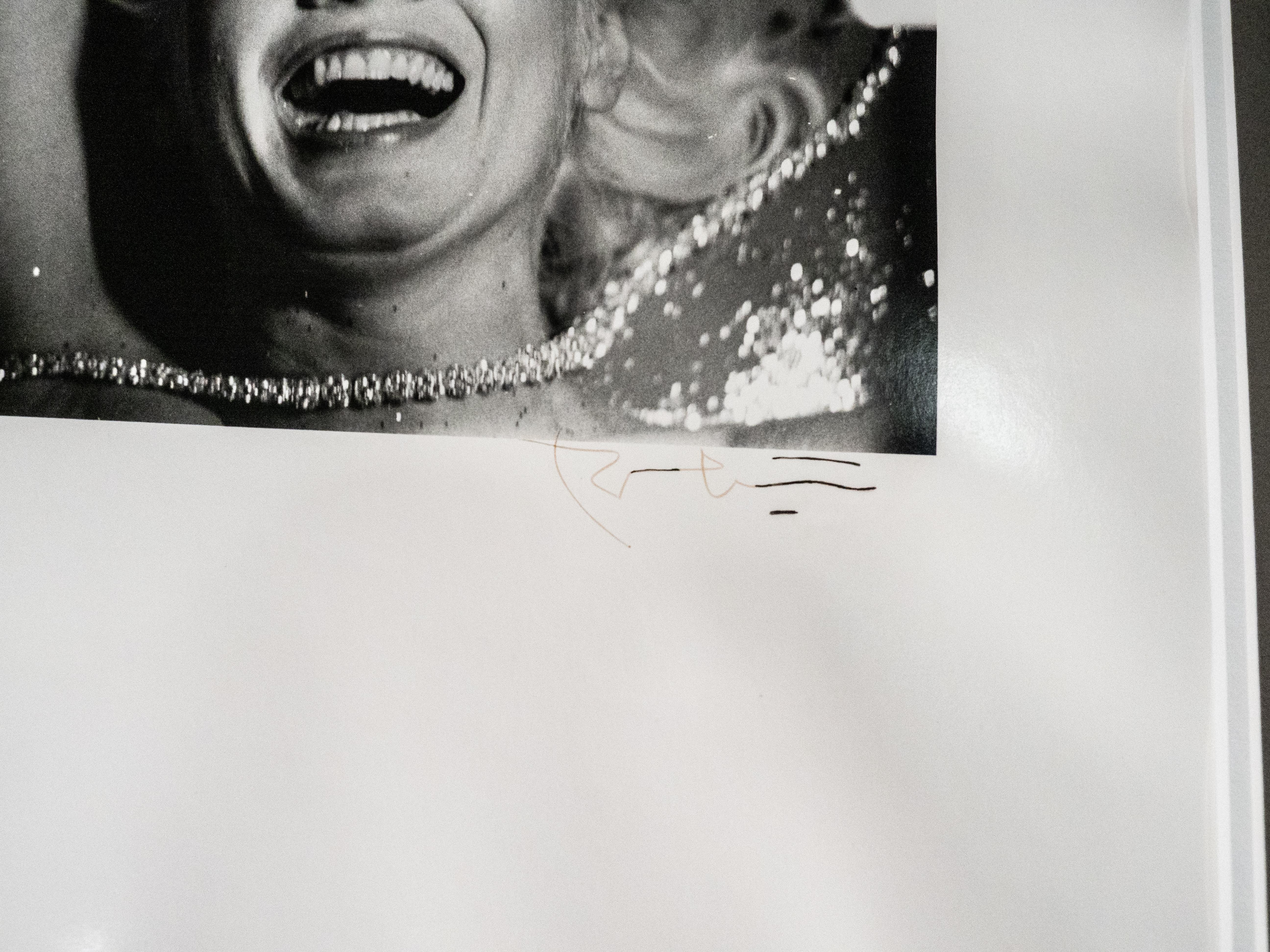 Sometimes referred to as Marilyn with Pearls or Marilyn Laughing into Camera.
Taken with 35mm hence the format, image size smaller. Printed on 16x20 paper. 
Signed on front in pen. Taken for Vogue 1962
