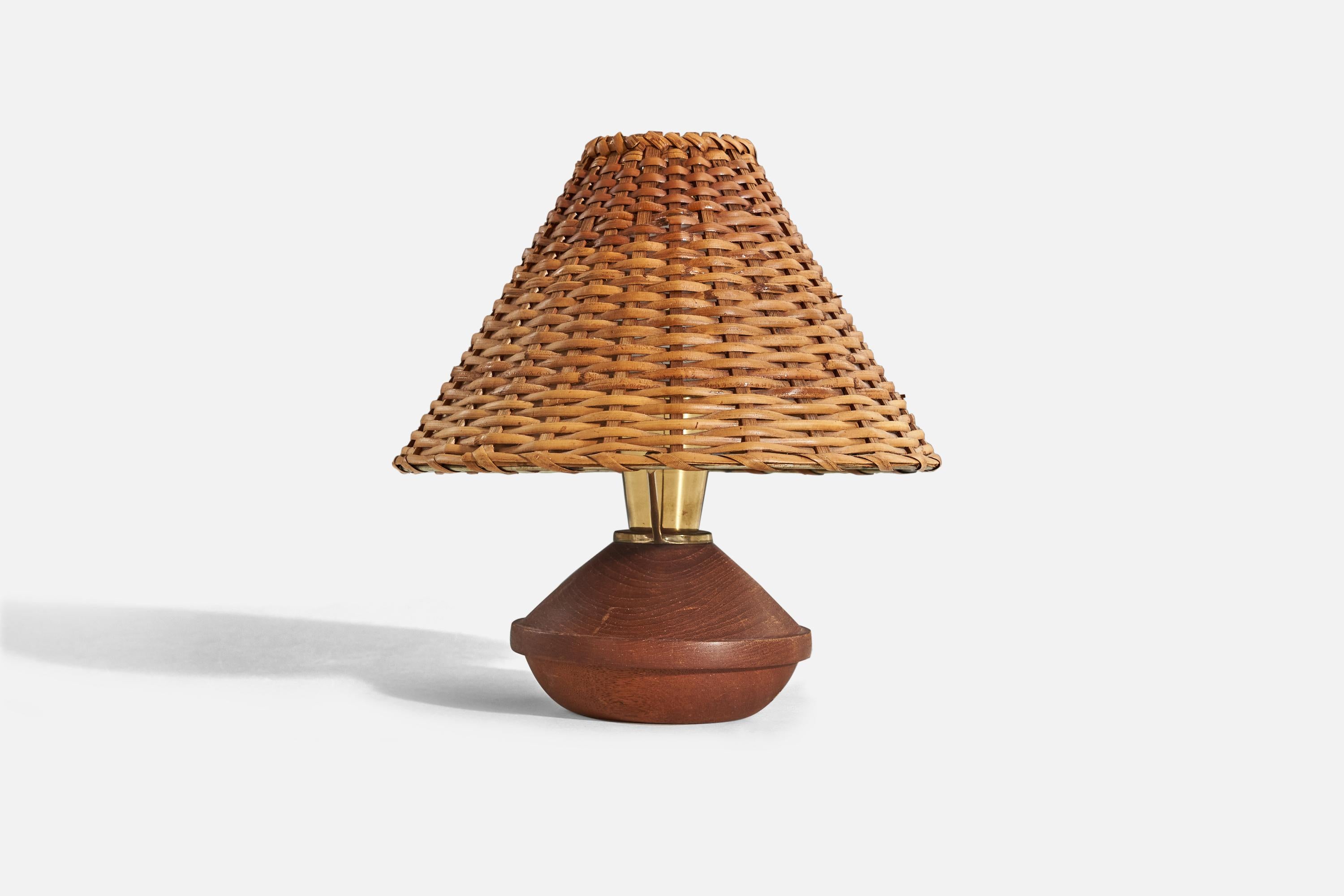 A teak, brass and rattan table lamp designed by Bertel Gardberg and produced by Lival Oy, Finland, 1960s. 

Sold with lampshade. 
Dimensions of Lamp (inches) : 5.93 x 9.62 x 5.68 (H x W x D)
Dimensions of Shade (inches) : 3 x 10.18 x 7 (T x B x