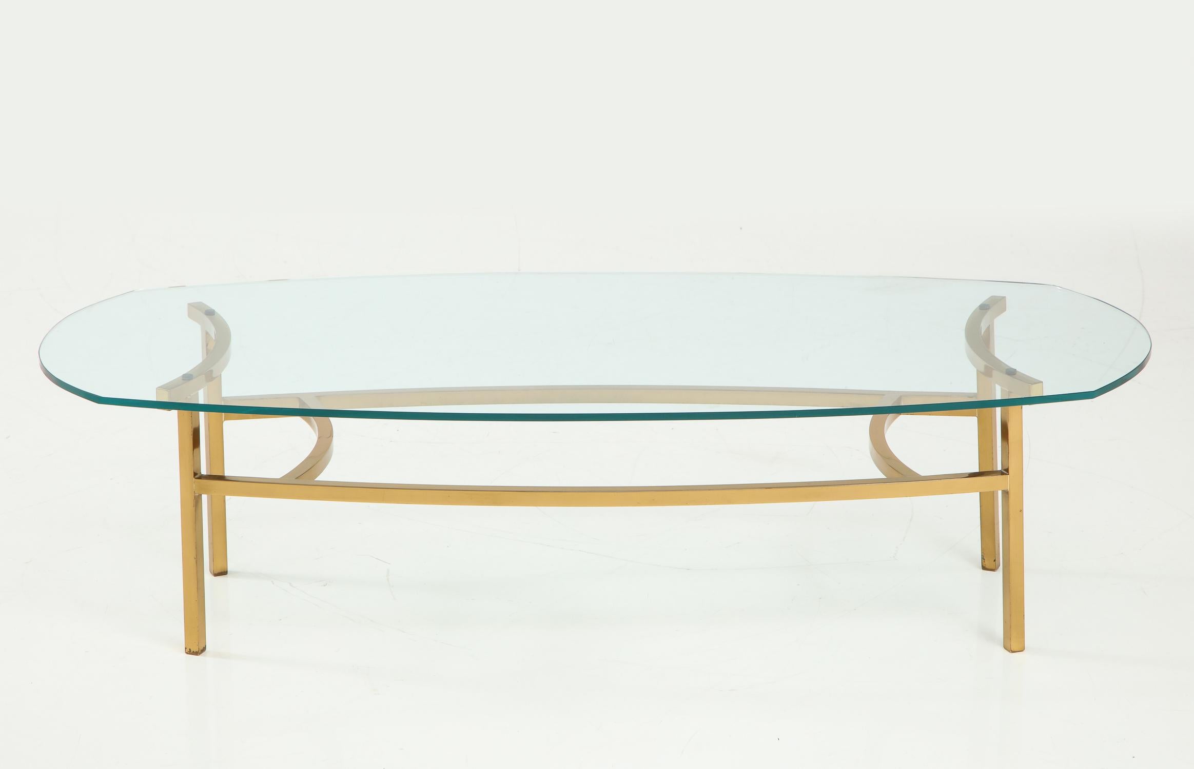 Spare and architectonic brass cocktail table with gently sinuous curves and original glass top. A Bertha Schaefer design for M. Singer and Sons, circa 1954. Rare to the market. Documented in “Modern Furnishings for the Home 2” by William J.