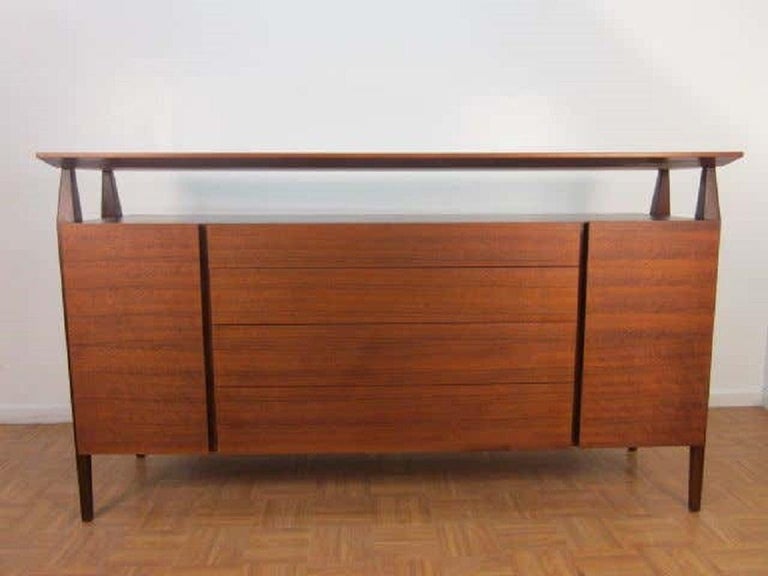 Bertha Schaefer credenza by Singer & Sons. Credenza features four drawers with two doors that each conceal storage with a single adjustable shelf. Nice lines.