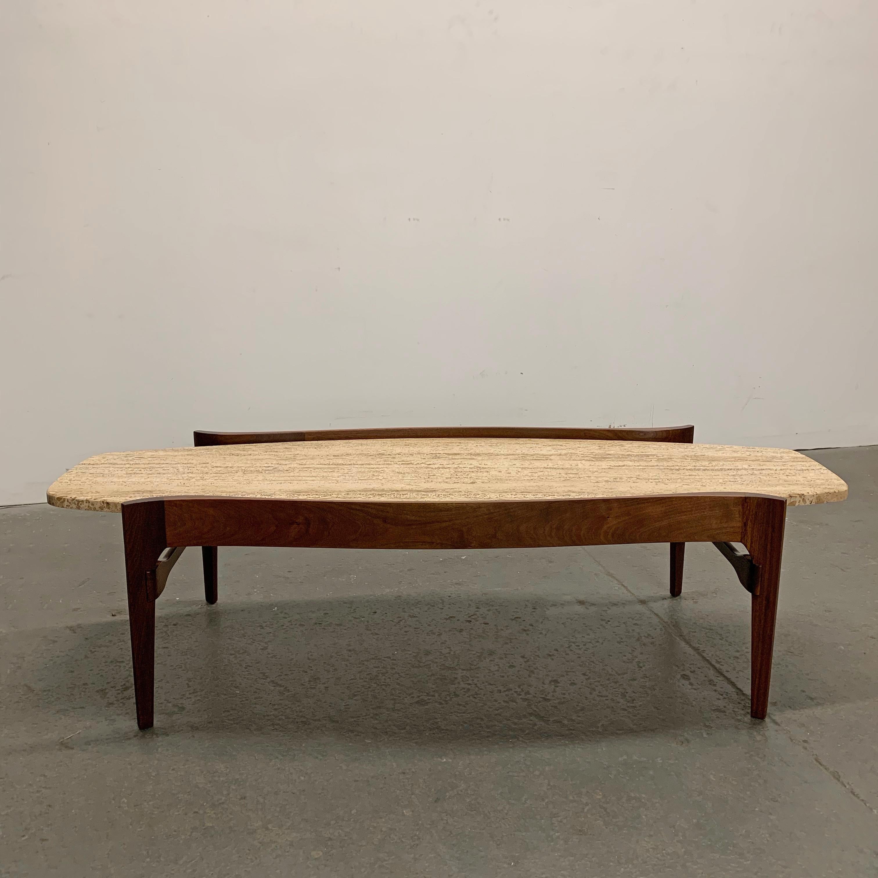 Mid-Century Modern coffee table by Bertha Schaefer for M. Singer & Sons features a travertine stone top resting in a beautifully detailed, contoured walnut frame.