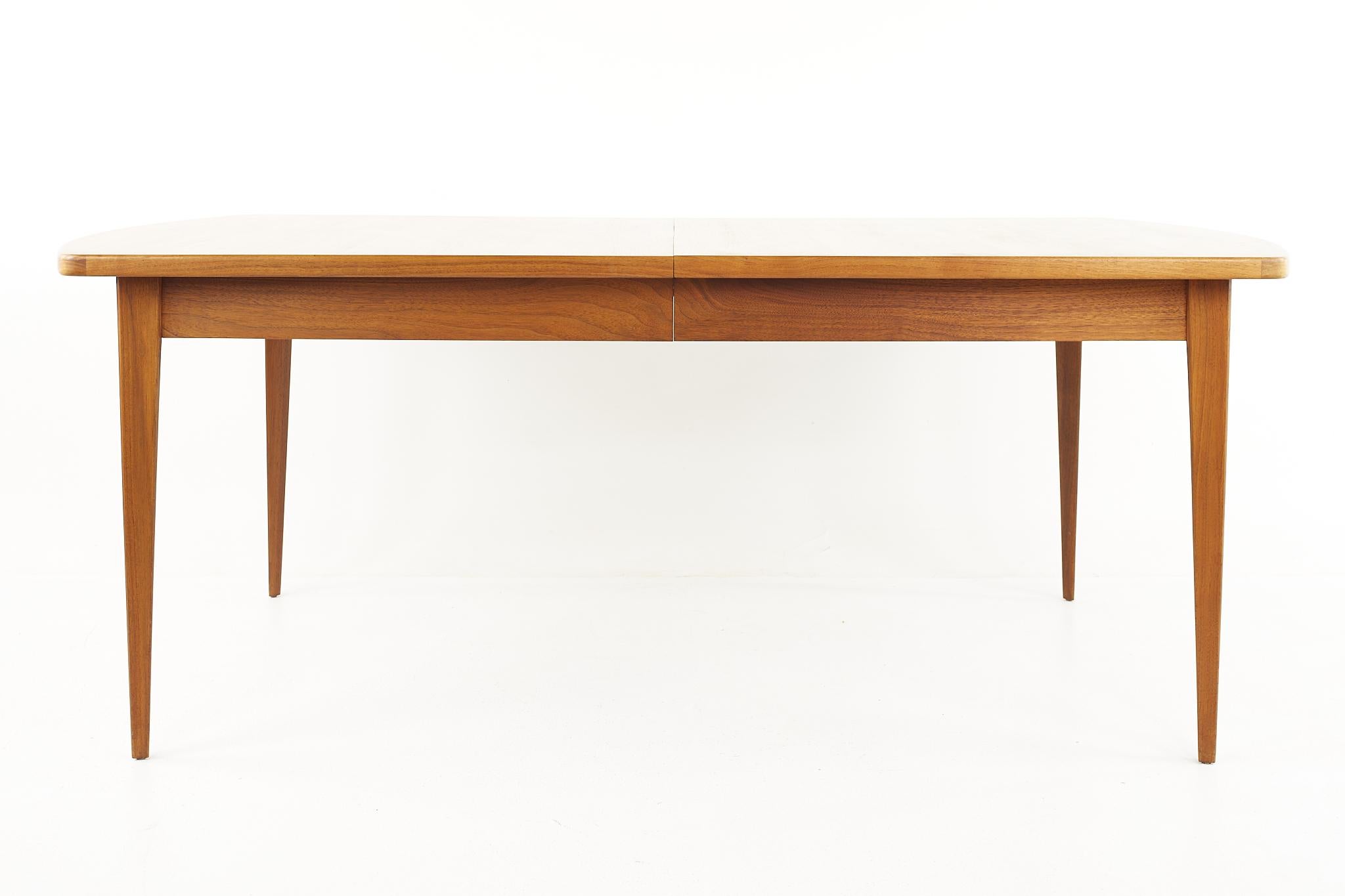 Bertha Schaefer for Singer and Sons Mid Century Walnut Expanding dining table

The table measures: 75.75 wide x 42.75 deep x 30 high, with a chair clearance of 25 inches; each leaf is 16 inches wide, making a maximum table width 123.75 inches when