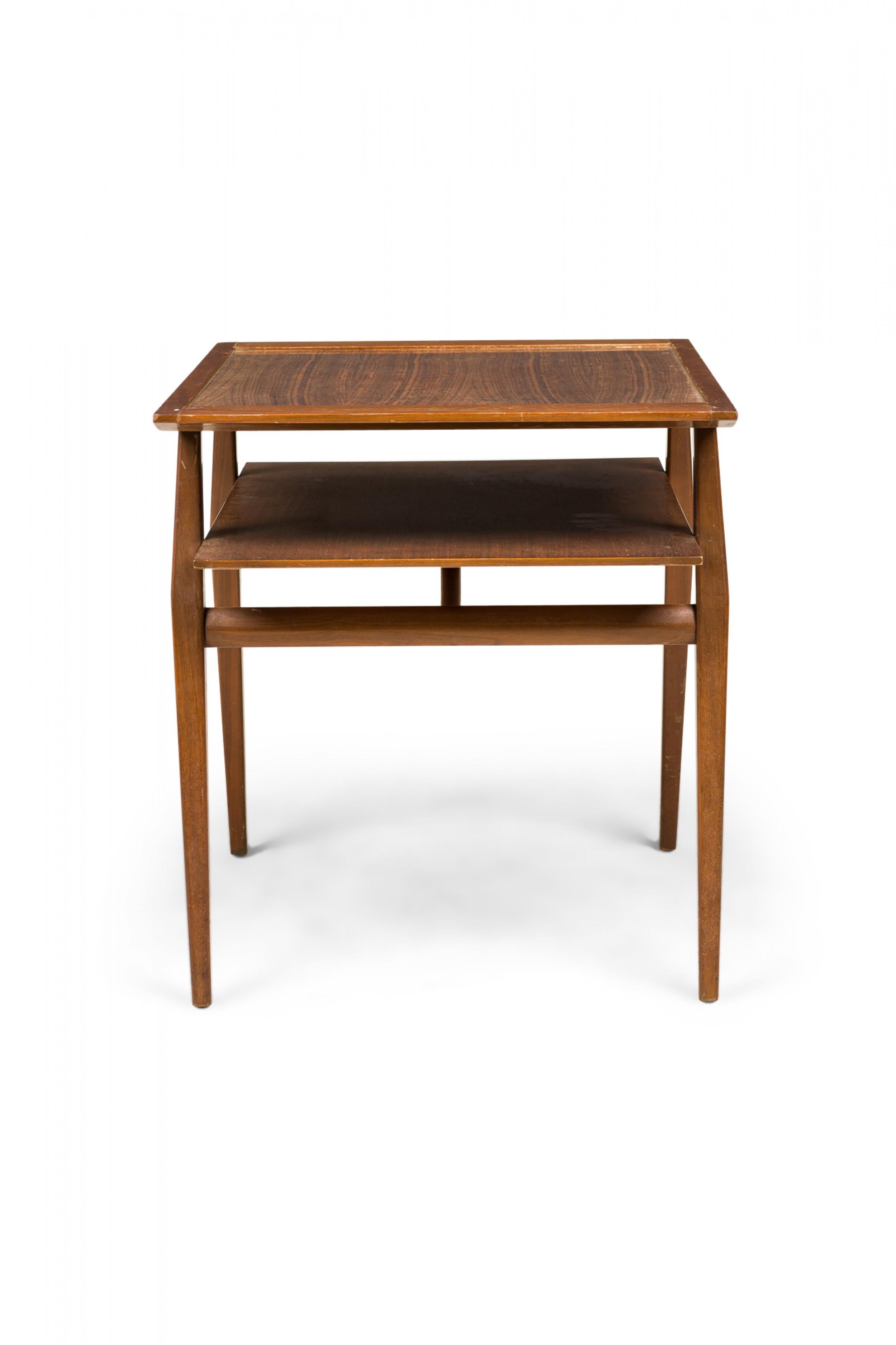 American Mid-Century two-tier end / side table with a walnut frame and inset laminate wood top, resting on four squared and tapered walnut legs. (BERTHA SCHAEFER FOR SINGER & SONS).