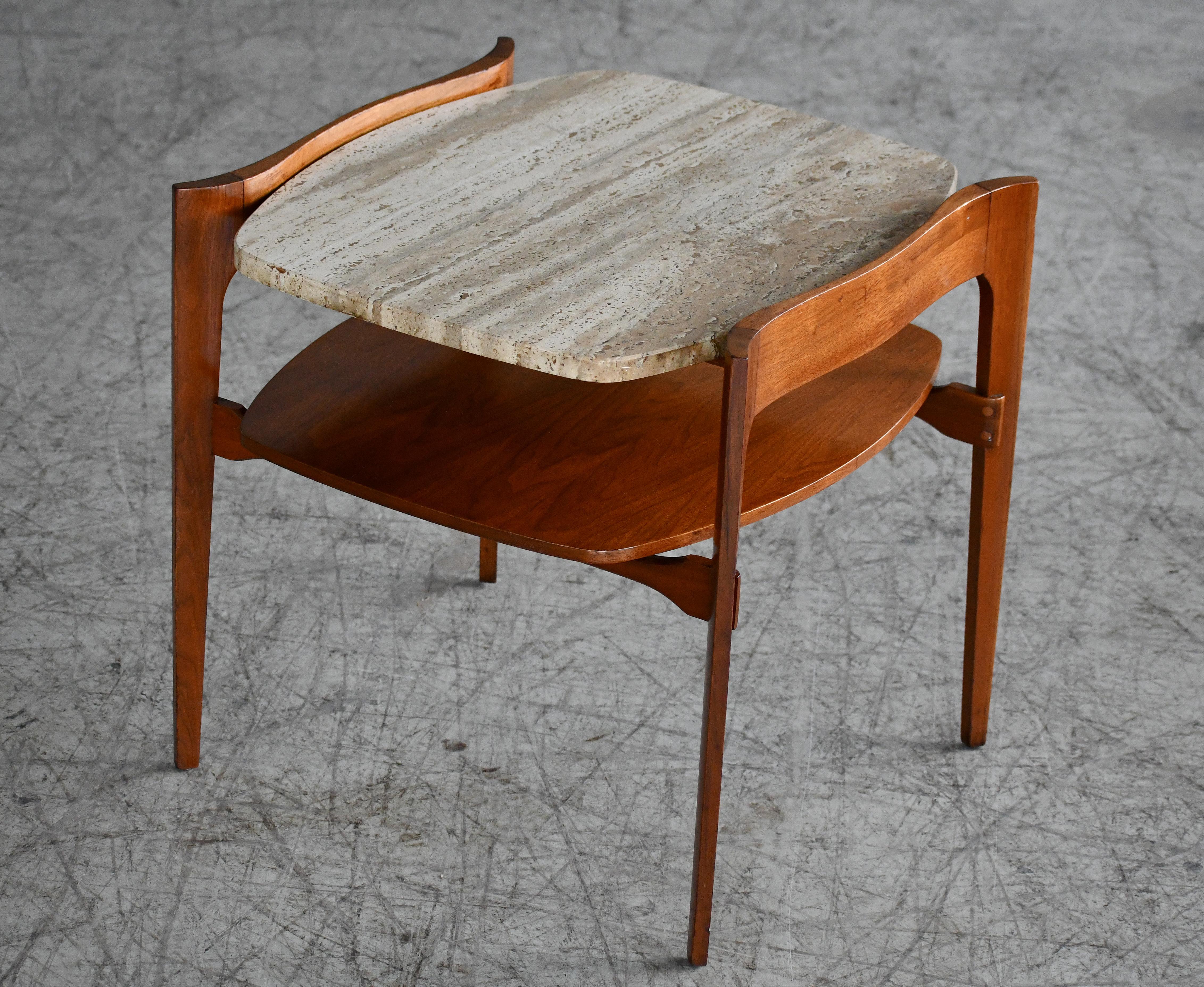 Fabulous boat tail shaped side or end table by M. Singer and Sons produced in the 1950s. Very sculptural walnut frame with 