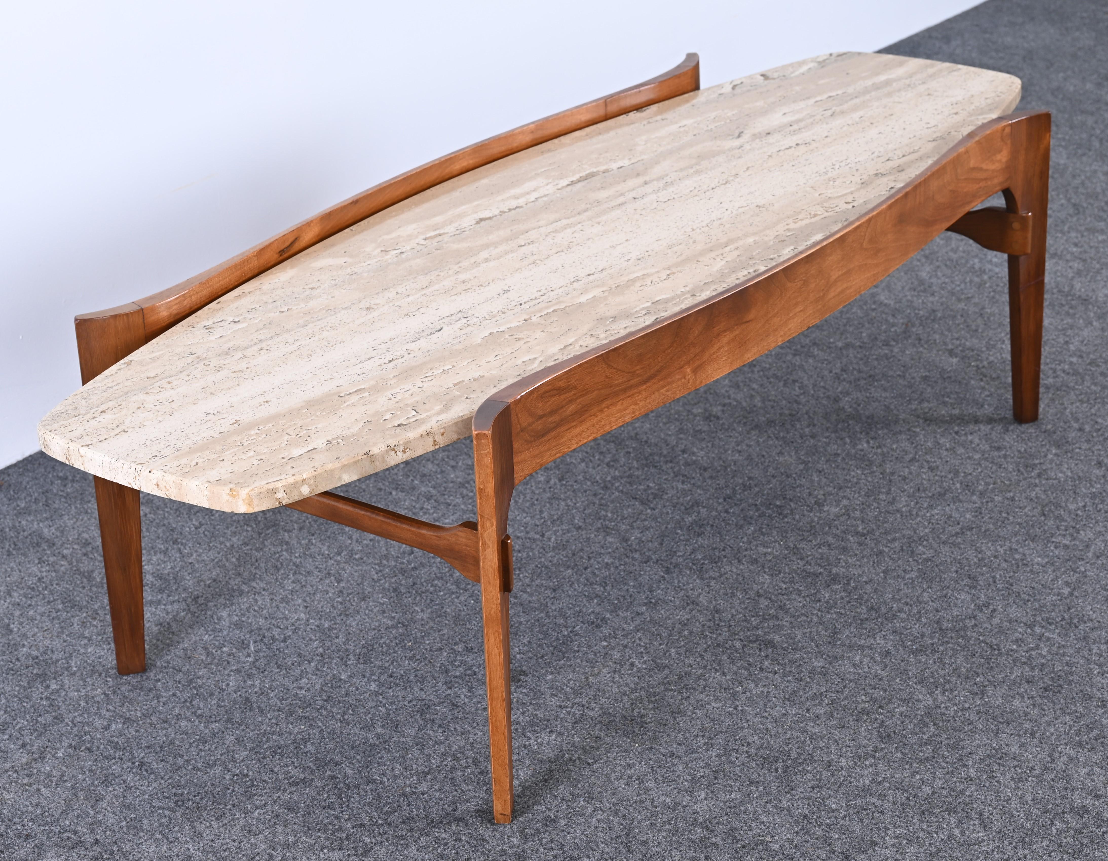 A sculptural Mid-Century Modern walnut and travertine coffee table by Bertha Schaefer for M. Singer & Sons. This beautiful travertine cocktail table would look great in any interior. The coffee table is structurally sound with age-appropriate wear.