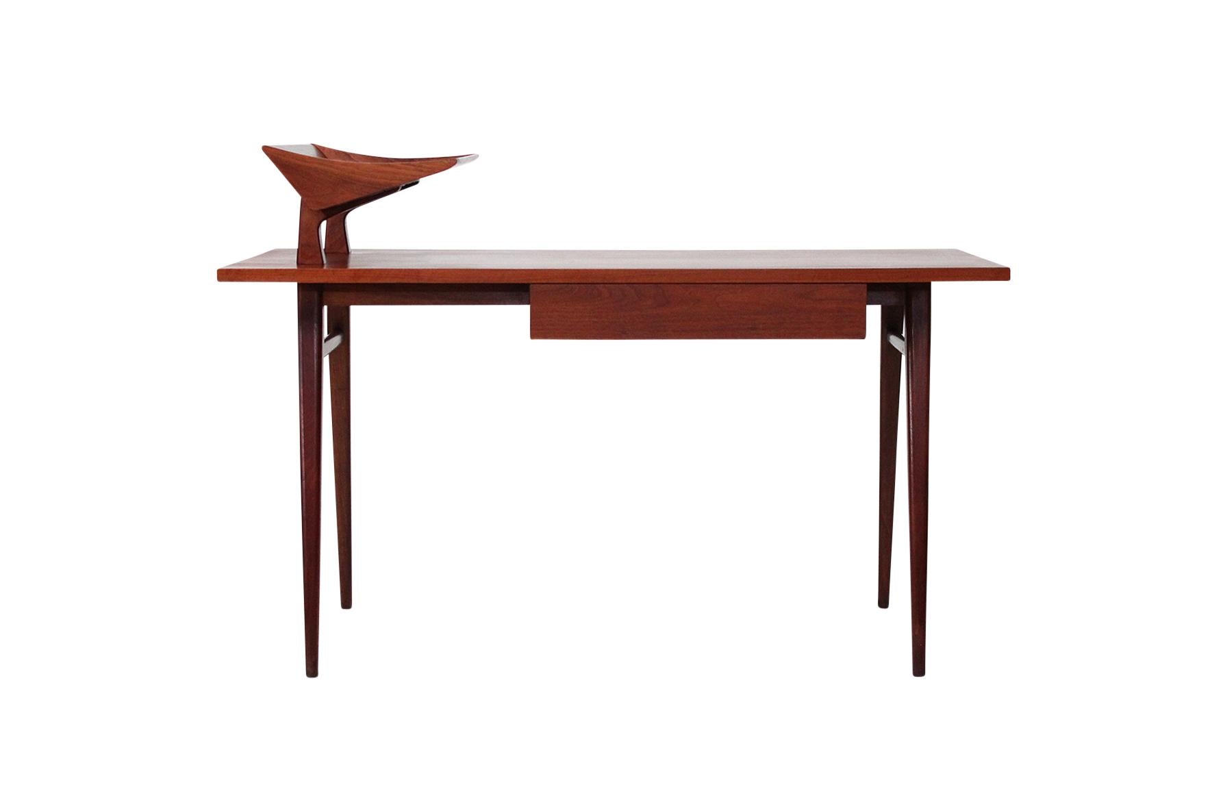 Writing desk designed by Bertha Schaeffer for M. Singer and Sons. Constructed from figured walnut with a sculptural elevated paper tray. Schaeffer began working with Singer and Sons in 1950 and created several pieces for them over an 11 year span.
 