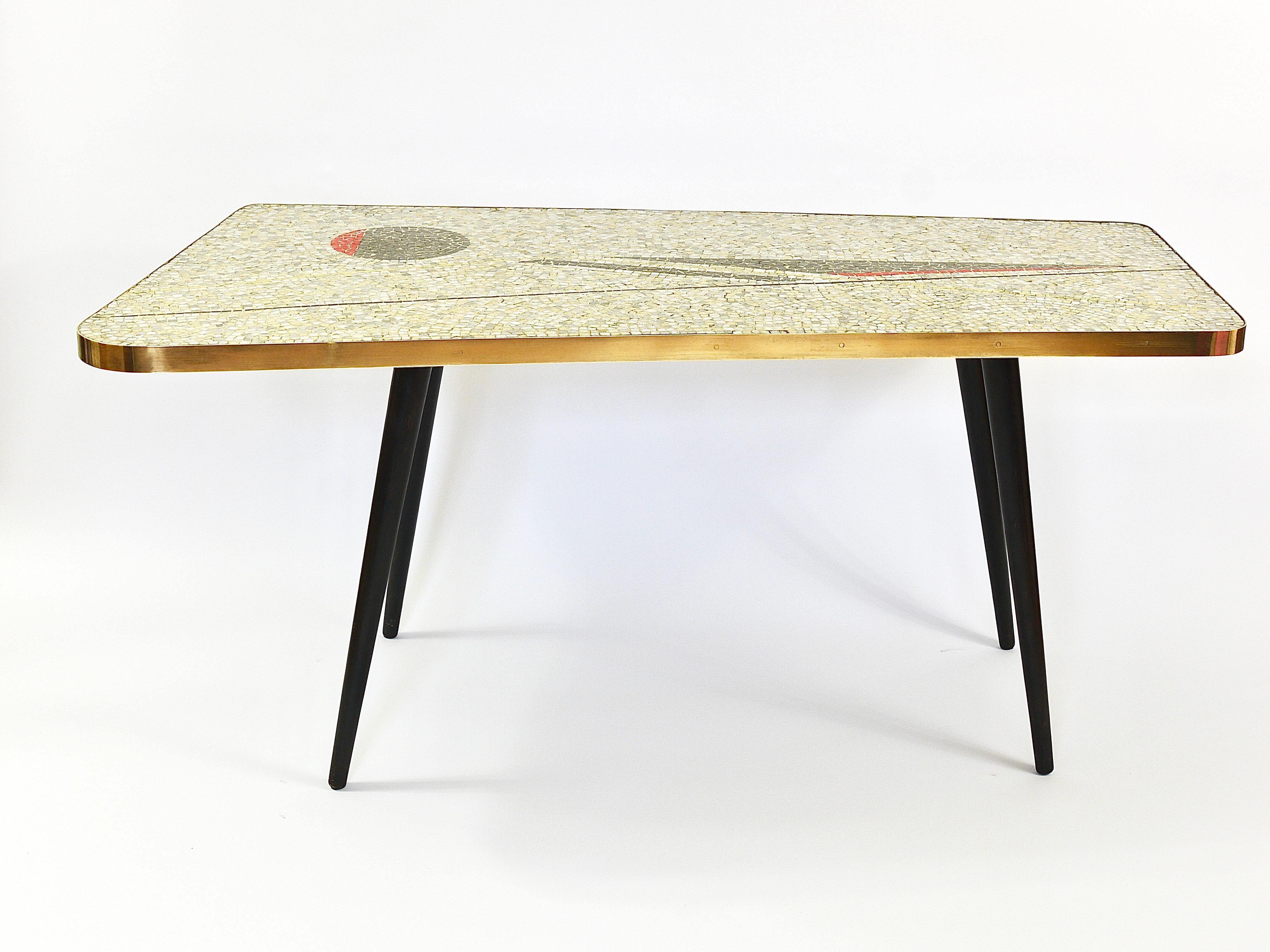 A sculptural Midcentury coffee or cocktail table with a lovely decorative glass tiles mosaic top, showing beautiful graphic shapes. Created by designer and artist Berthold Müller - Oerlinghausen (1893-1979), Germany. This unique sofa table has a
