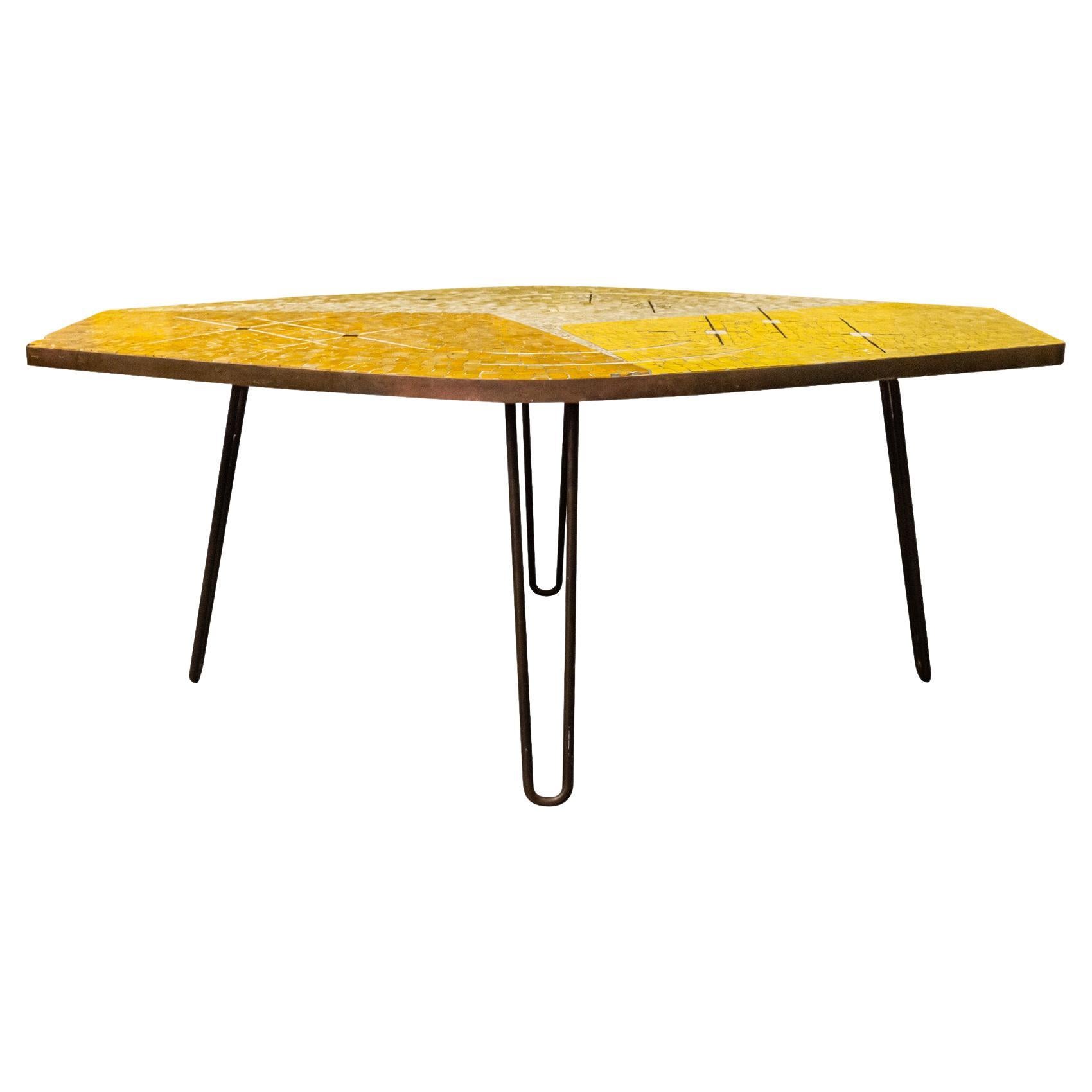 Berthold Müller (1893-1979), table,
Quadripod iron base,
Hexagonal tray composed of small mosaic ceramic tiles with geometric decoration in yellow and orange tones,
circa 1950, Germany.

Measures : width 126 cm, depth 76 cm, height 49