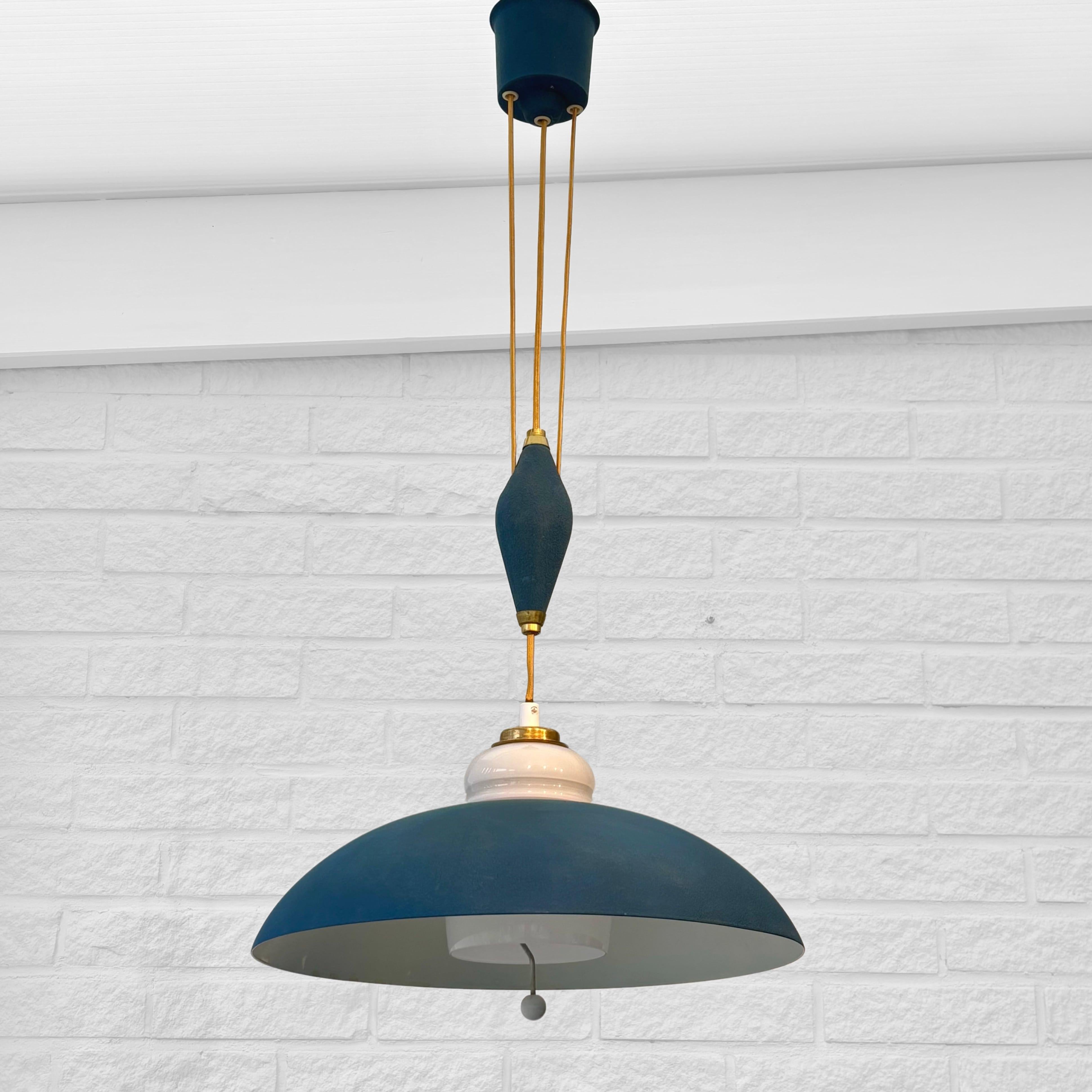 A modernist rise-and-fall pendant lamp, model 33087, designed in the 1950s by Bertil Brisborg for the renowned Swedish department store Nordiska Kompaniet. Crafted from steel lacquered in a deep blue color with brass details, and featuring an