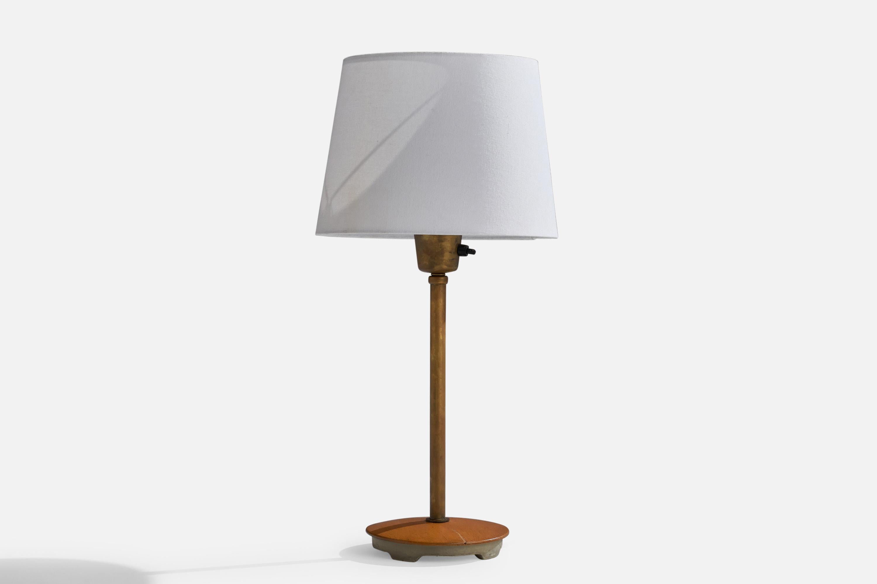 An adjustable brass, oak and iron table lamp designed by Bertil Brisborg and produced by Nordiska Kompaniet, Sweden, 1940s.

Dimensions of Lamp (inches): 15.25” H x 6” Diameter
Dimensions of Shade (inches): 8” Top Diameter x 9.75” Bottom Diameter x