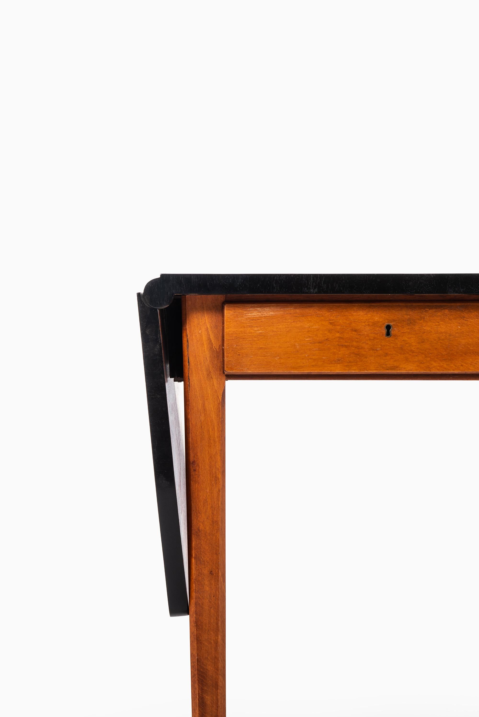 Rare drop-leaf desk designed by Bertil Fridhagen. Produced by Bodafors in Sweden.