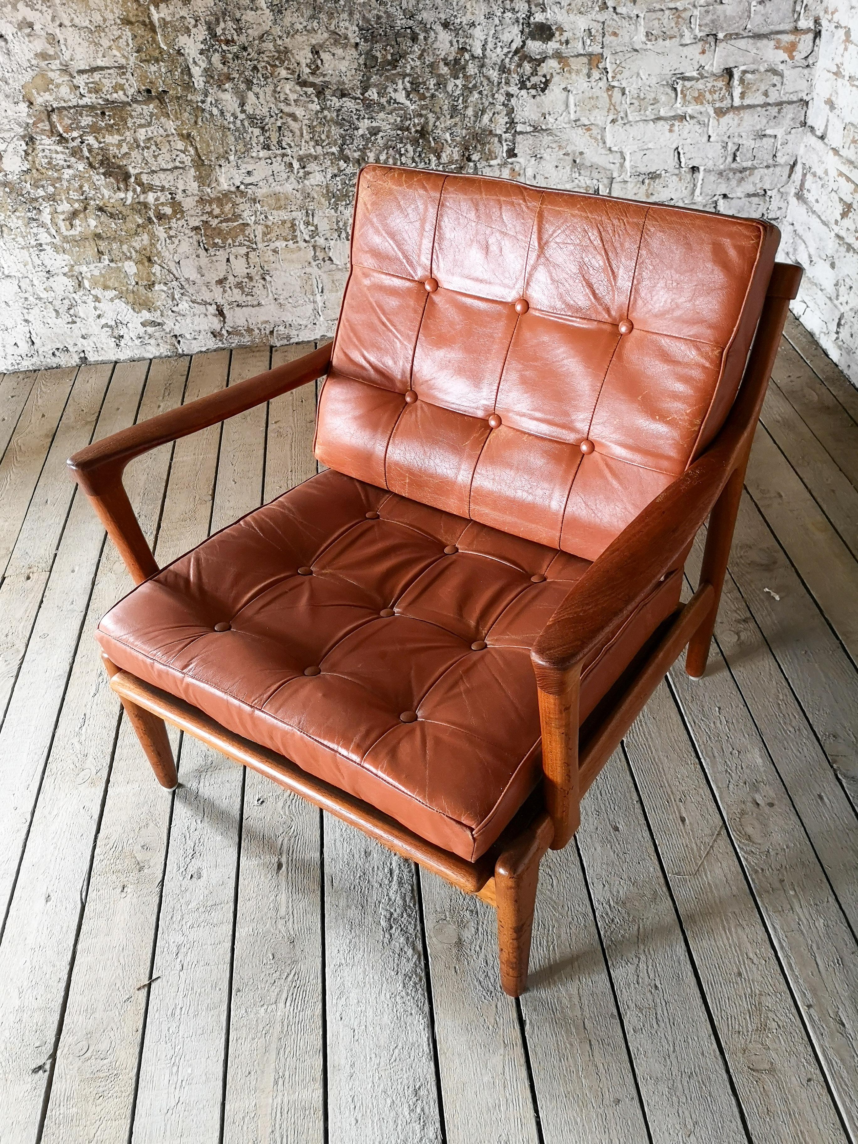 Easy chair model Kuba designed by Bertil Fridhagen. Produced by Bröderna Andersson in Sweden. Original Cognac brown leather and teak gives this chair a cool vintage look. 

New fabric stripes to the chair have been made, the leather with a little