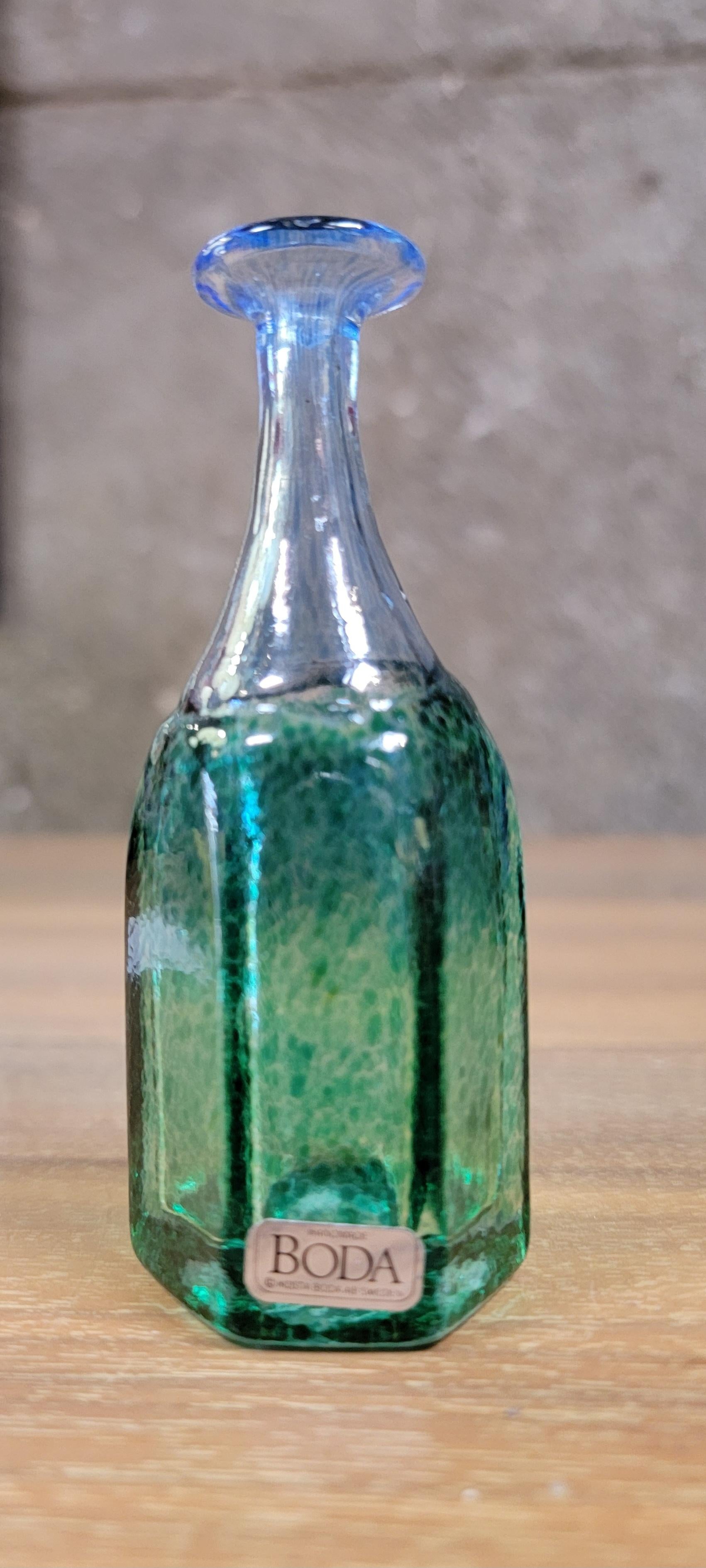 Accompanying pair of miniature hand blown art glass vases by Bertil Vallien for Kosta Boda. Sweden Circa. 1980's. Retaining (1) paper label and each piece etched signed on base.

4.5 inches high.
2.5 inches deep.
2.5 inches wide.

2.5 inches high
2