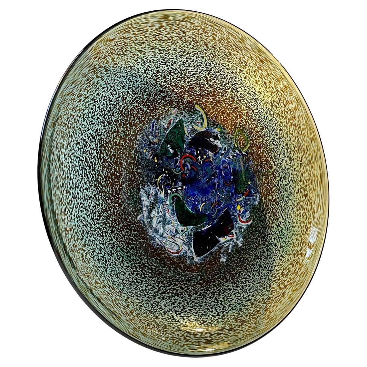 A spectacular hand-signed artist collection dish or bowl by the Swedish glass designer Bertil Vallien. It is called Meteor for obvious reasons and is executed in a rainbow of diffrent colors fusioned together with advanced techniques. This example