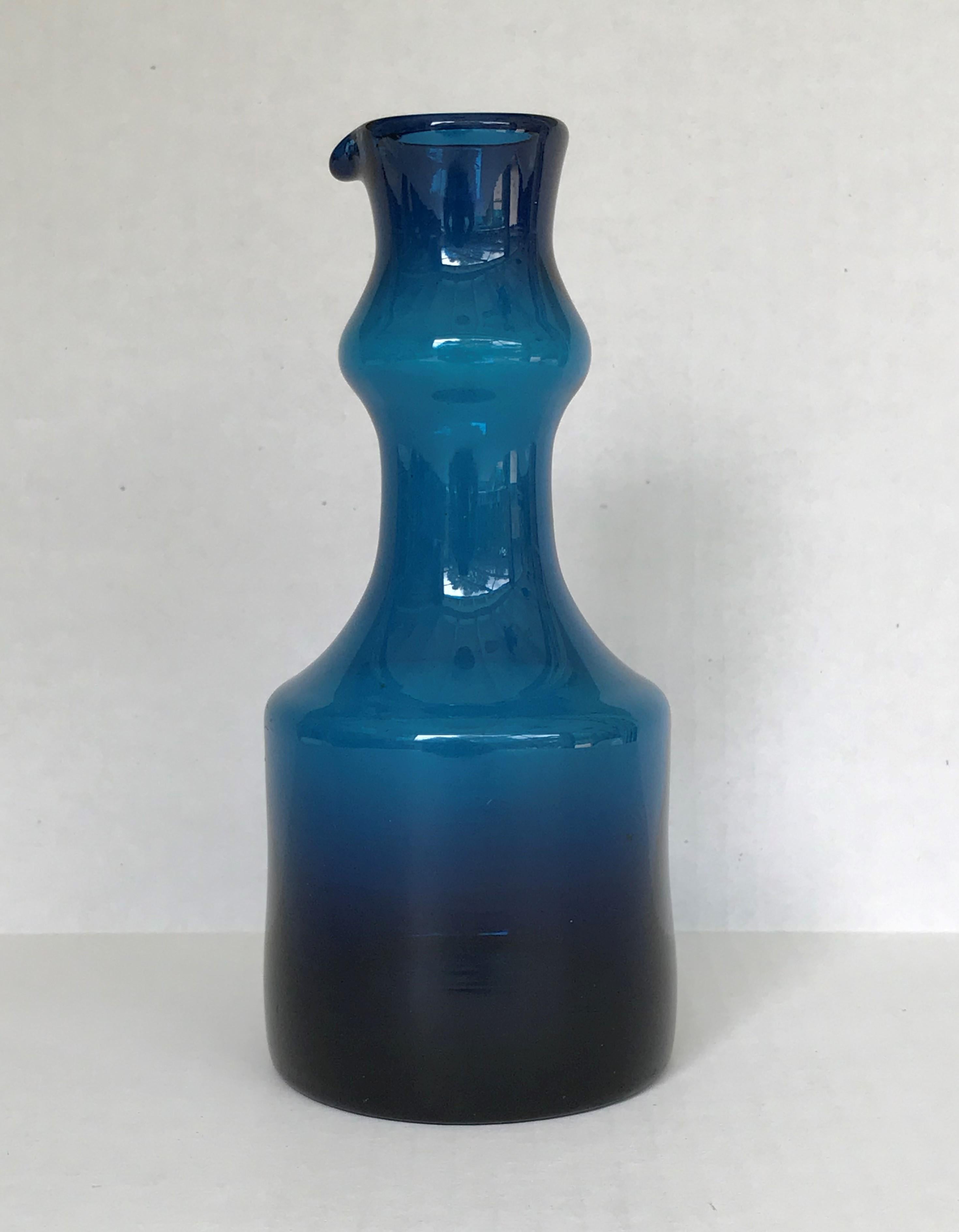 Beautiful Mid-Century Modern deep blue vessel with spout by Swedish glass maker Bertil Vallien (b. 1938) from the 1960s.
Vallien studied ceramics at Konstfack Art School in Stockholm in 1955 and became an accomplish ceramist. In 1959, Stig Lindberg