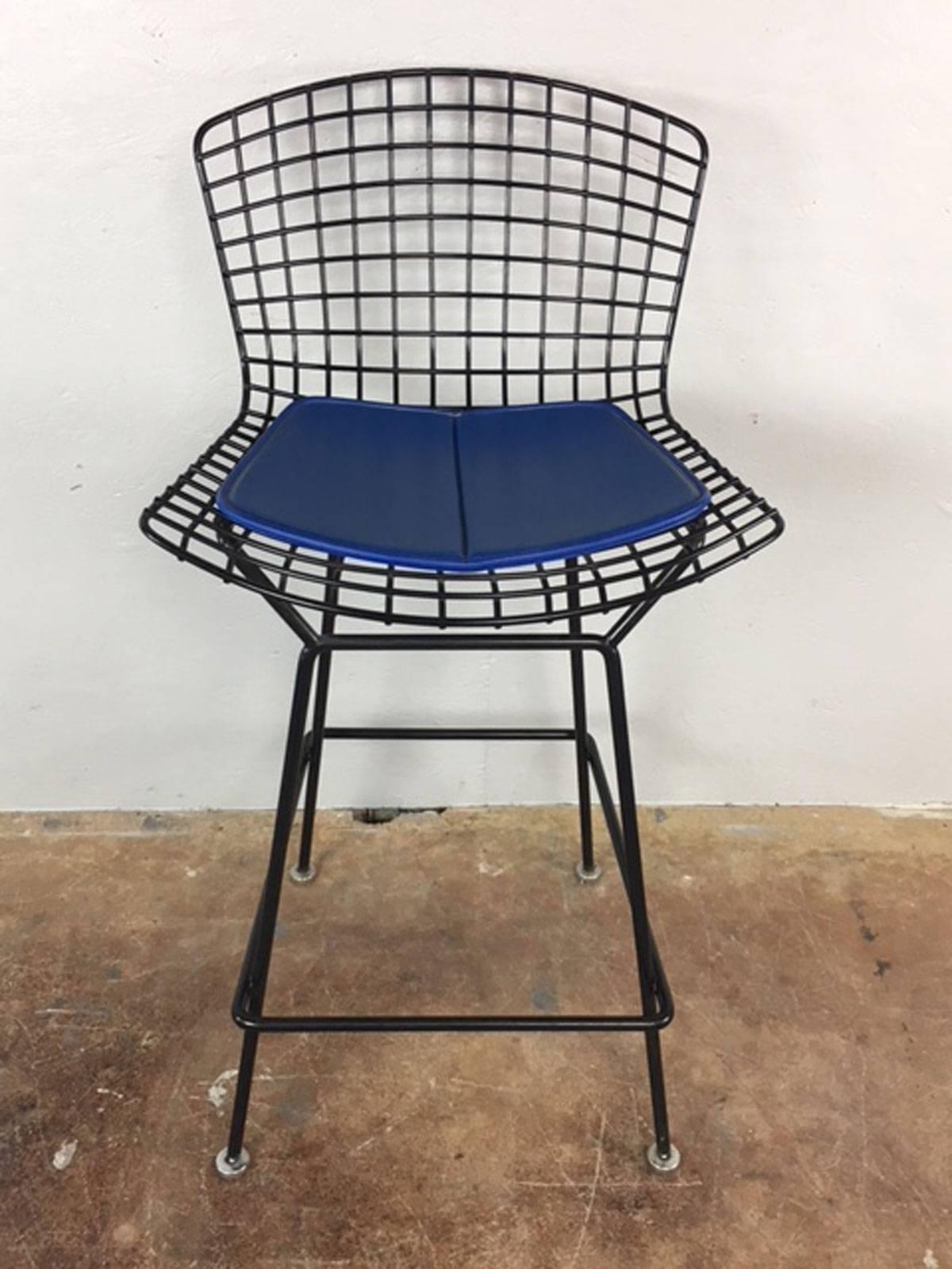 Sold in pairs...these Bertoia bar stools in black metal have original vinyl blue seat pads. Excellent condition. 

Price reflected is for two stools.  ONLY two of these stools remain in stock 

Seat height is 28.5 inches.