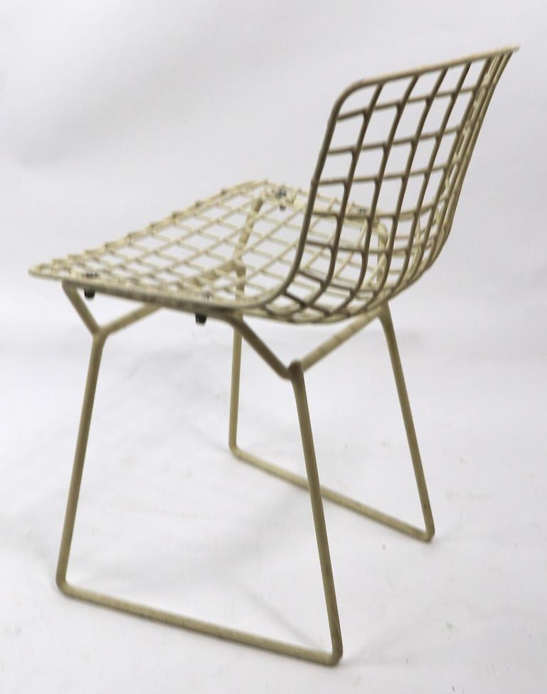 Classic midcentury child's chair designed by Harry Bertoia for Knoll. This example is circa 1960s, it is in good condition, showing only expected cosmetic wear, normal and consistent with age. The seat pad shows significant wear, and is included,