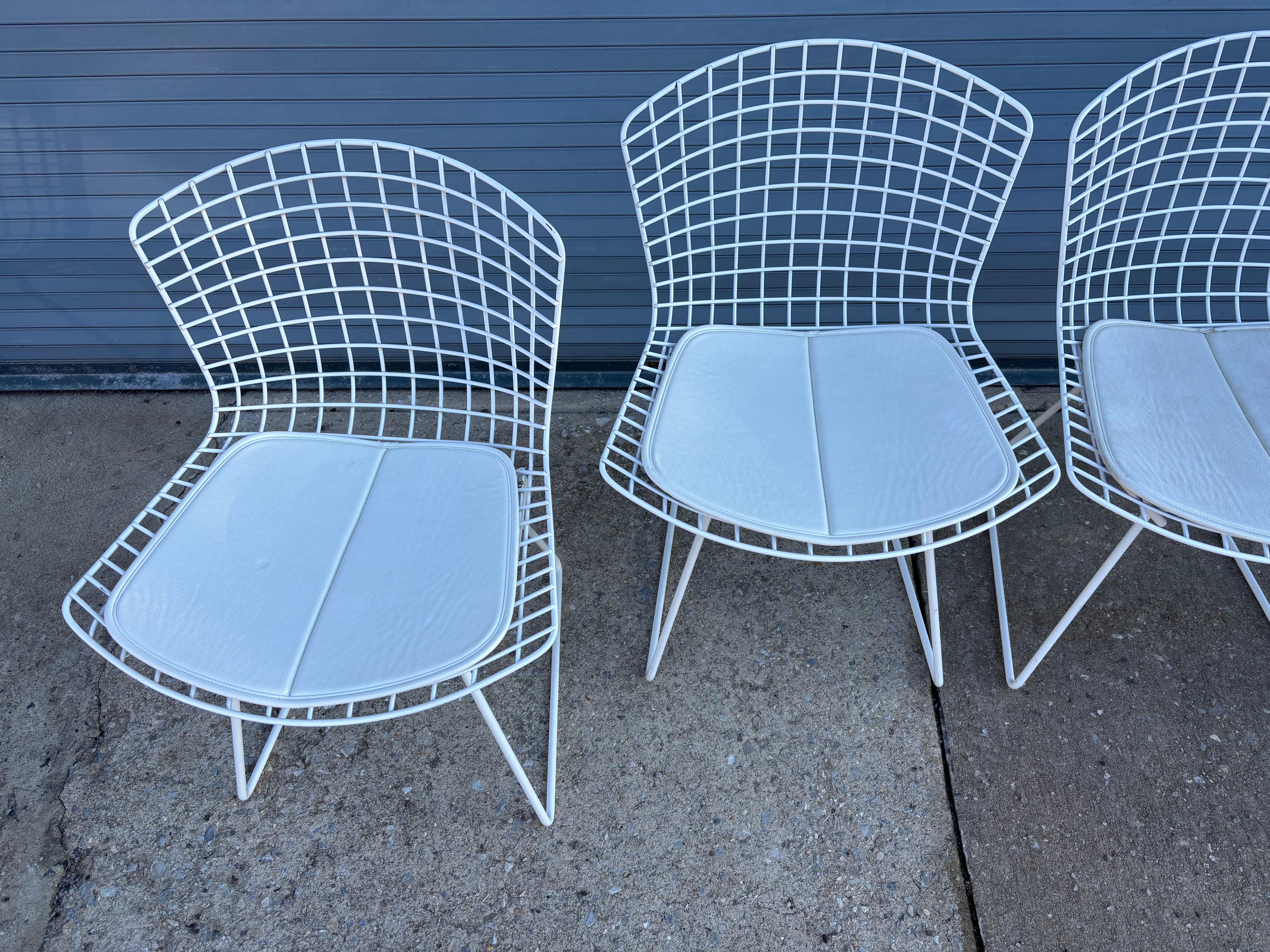 Harry Bertoia for Knoll Wire Side Chairs with white vinyl pads.  Newer models that are still in very nice shape.  Classic design that still looks fresh and new!  Easy to move around and use all over the house.