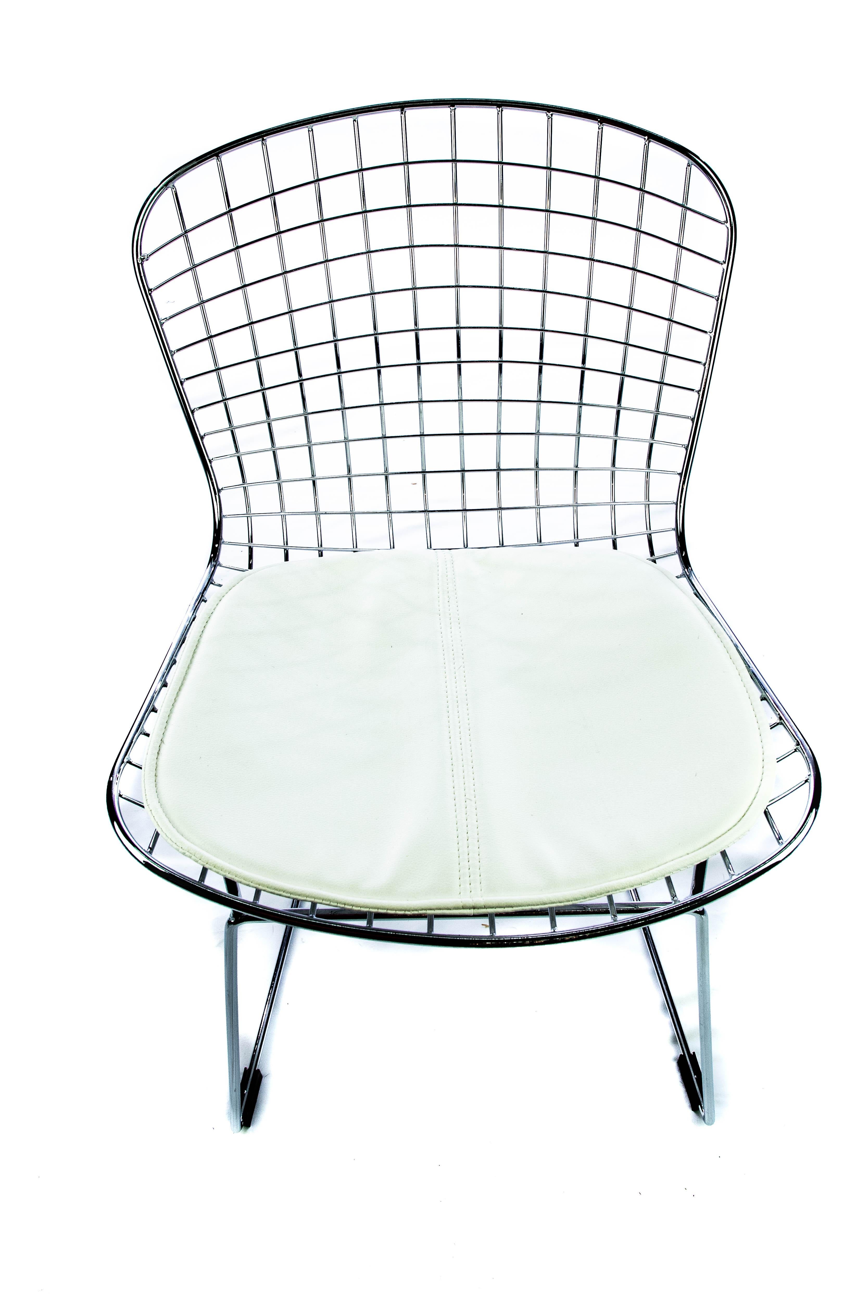 Enjoy the airy, simplicity of the modern chrome mesh chair in the style of Betoria. Built with a solid chrome steel frame, this chair features a wide, curved back with a grid design that is geometric. The seat of the chair features an appealing