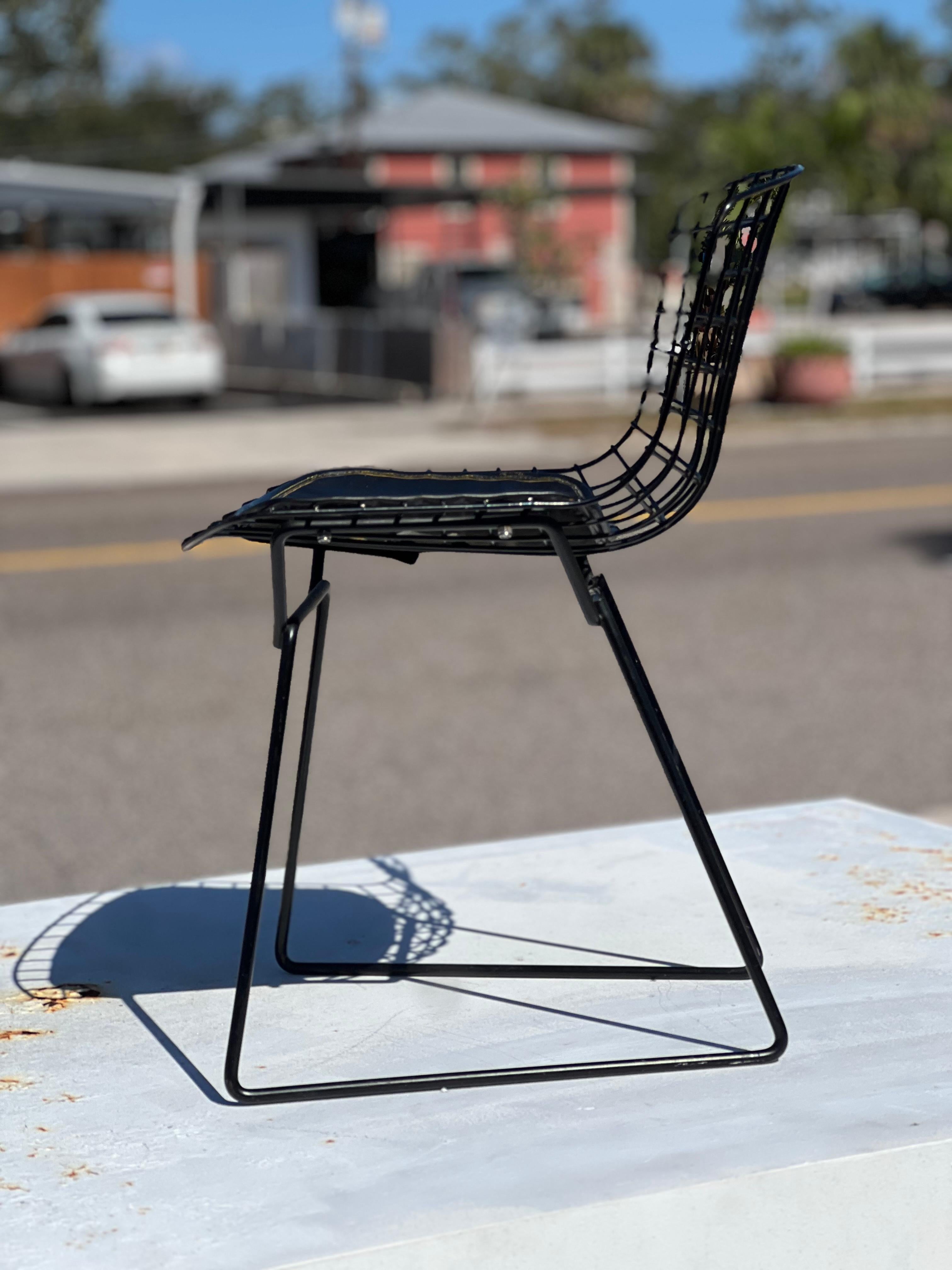 A Harry Bertoia for Knoll child's chair with original seat pad and Knoll label. A rare find, in matching black color.