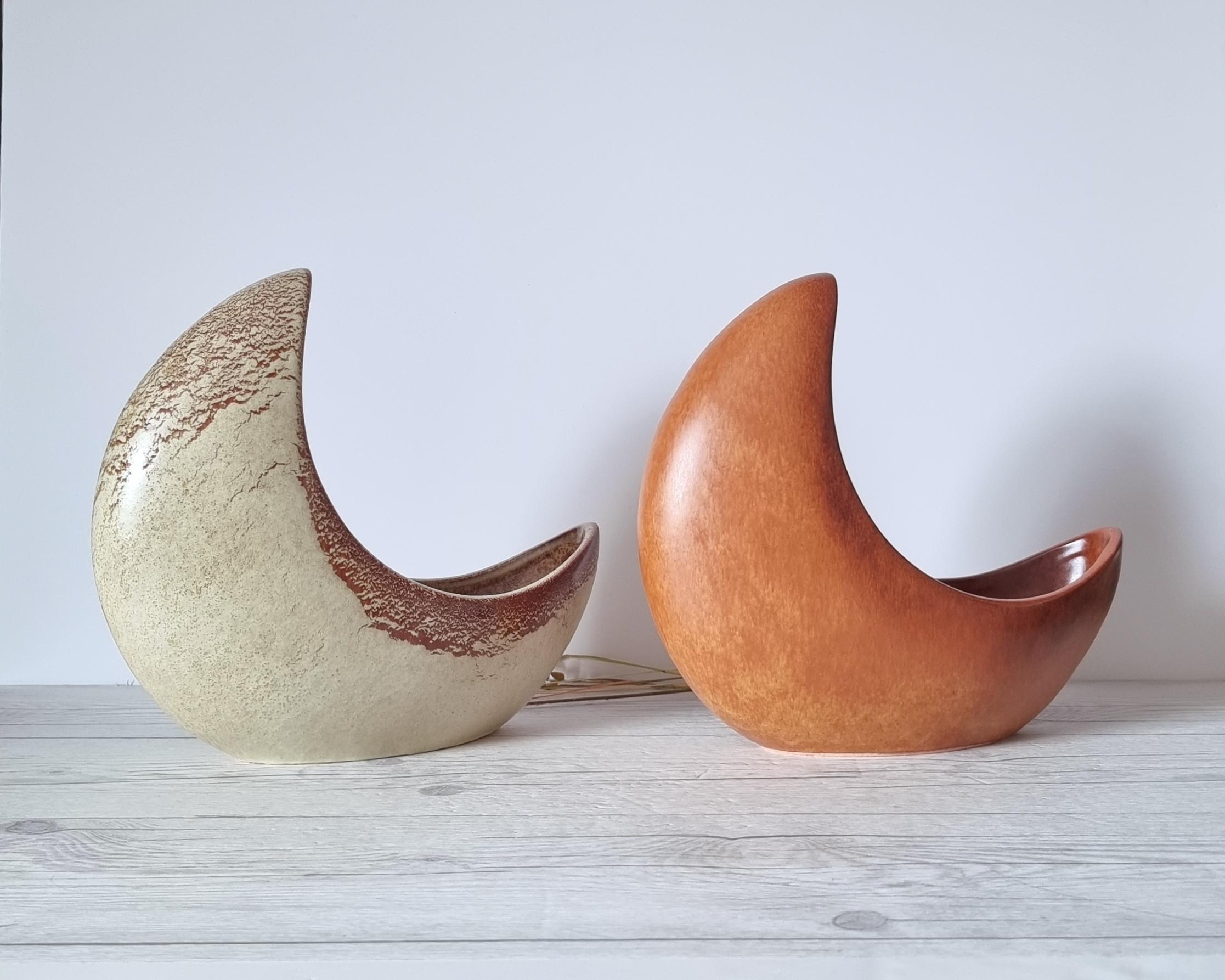 This exceptionally sculptural work of Italian mid-century Modern design by the Bertoncello Ceramiche D'Arte (estd. c.1956 - c.1999). The form is that of a 3D crescent moon partially embedded into the surface the piece rests upon. The sumptuous glaze