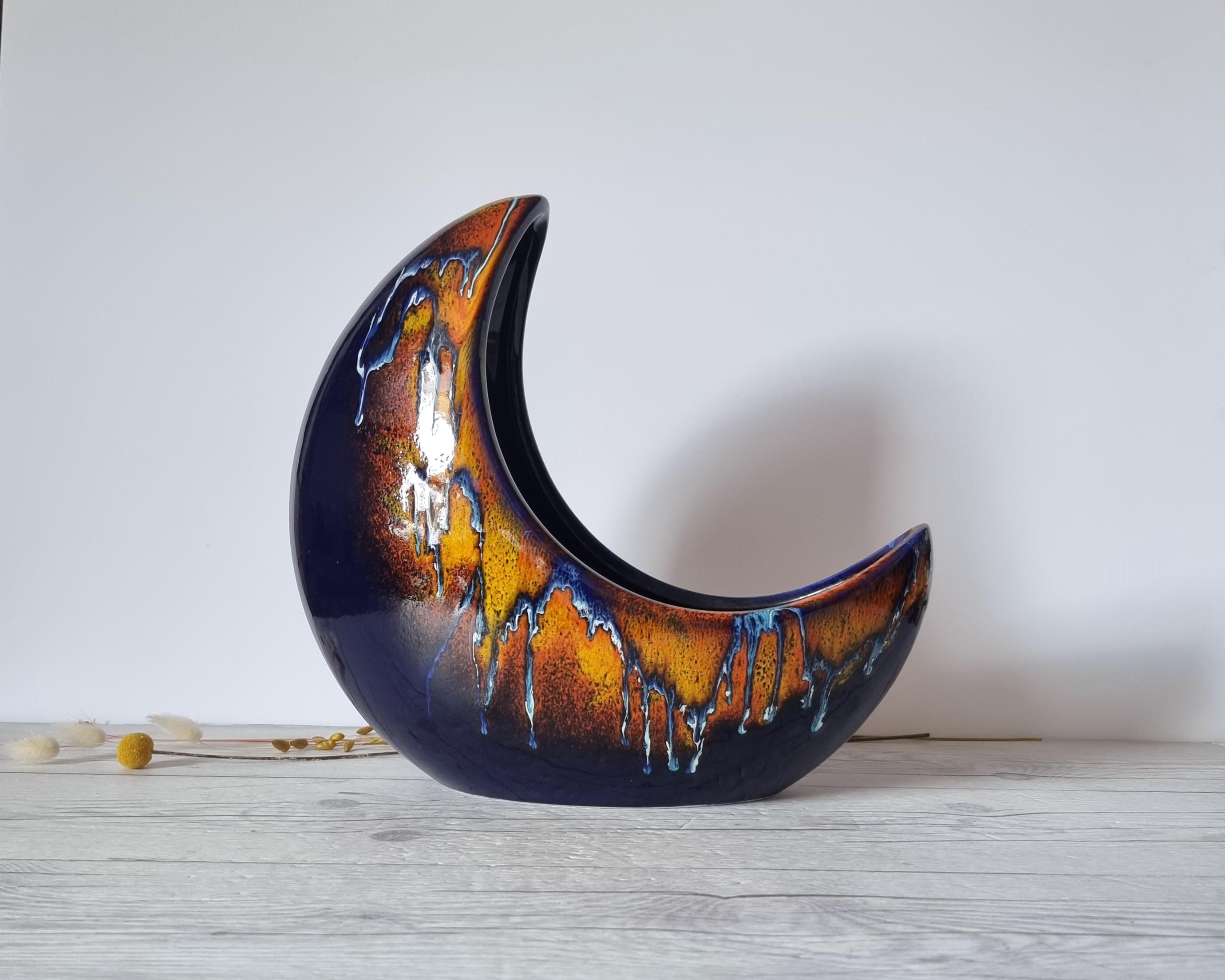 This exceptional and rare sculptural work of Italian mid-century Modern design by the Bertoncello Ceramiche D'Arte (estd. c.1956 - c.1999). The form is that of a 3D crescent moon partially embedded into the surface the piece rests upon. Though the