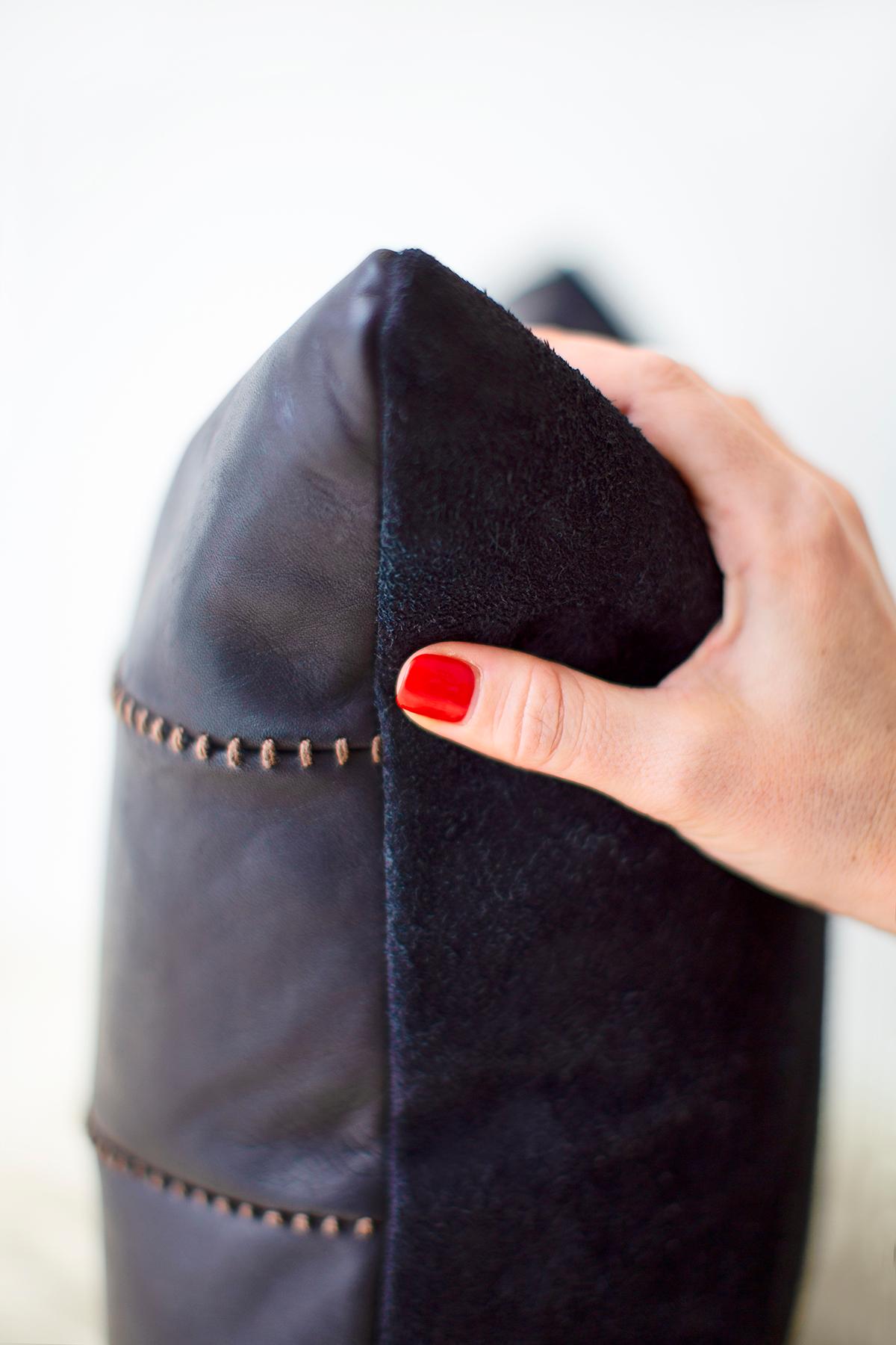 This Mode Black Leather Throw Pillow is made in the heart of Ohio, USA with a high-grade leather front and a suede back. The pattern of the stitching between the 3 leather panels is what makes these shine. They are stuffed (and shipped) with a down